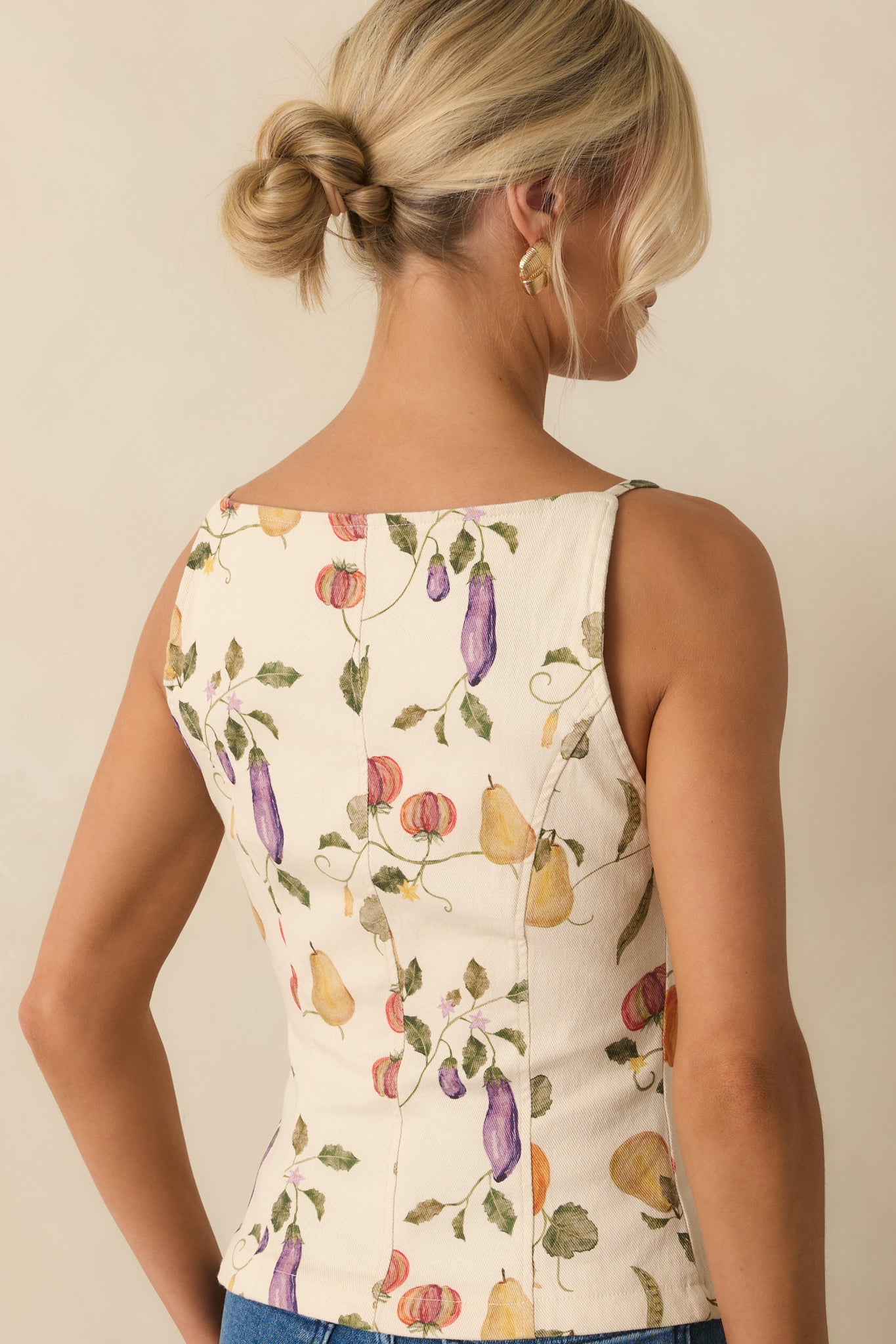 Back view of ivory spaghetti strap top with fitted paneled tailoring and smooth finish.