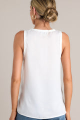 Back view of this white tank top that showcases a classic scoop neckline, stylish slits up the sides of the bottom hem, and a lightweight fabric for effortless comfort and style.