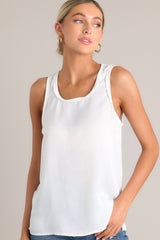 Angled front view of this white tank top that showcases a classic scoop neckline, stylish slits up the sides of the bottom hem, and a lightweight fabric for effortless comfort and style.