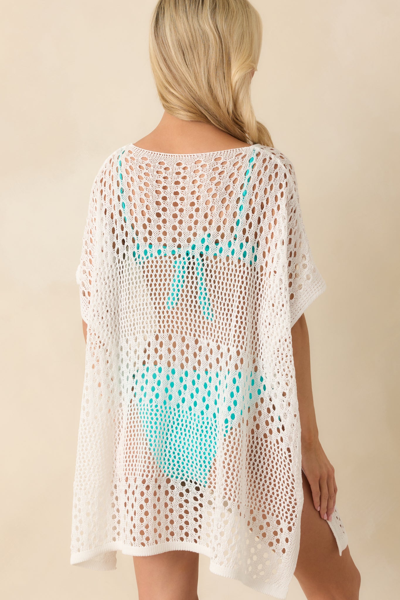 A back view displaying the lightweight, sheer quality of the knit fabric and the relaxed drape down to the hem.
