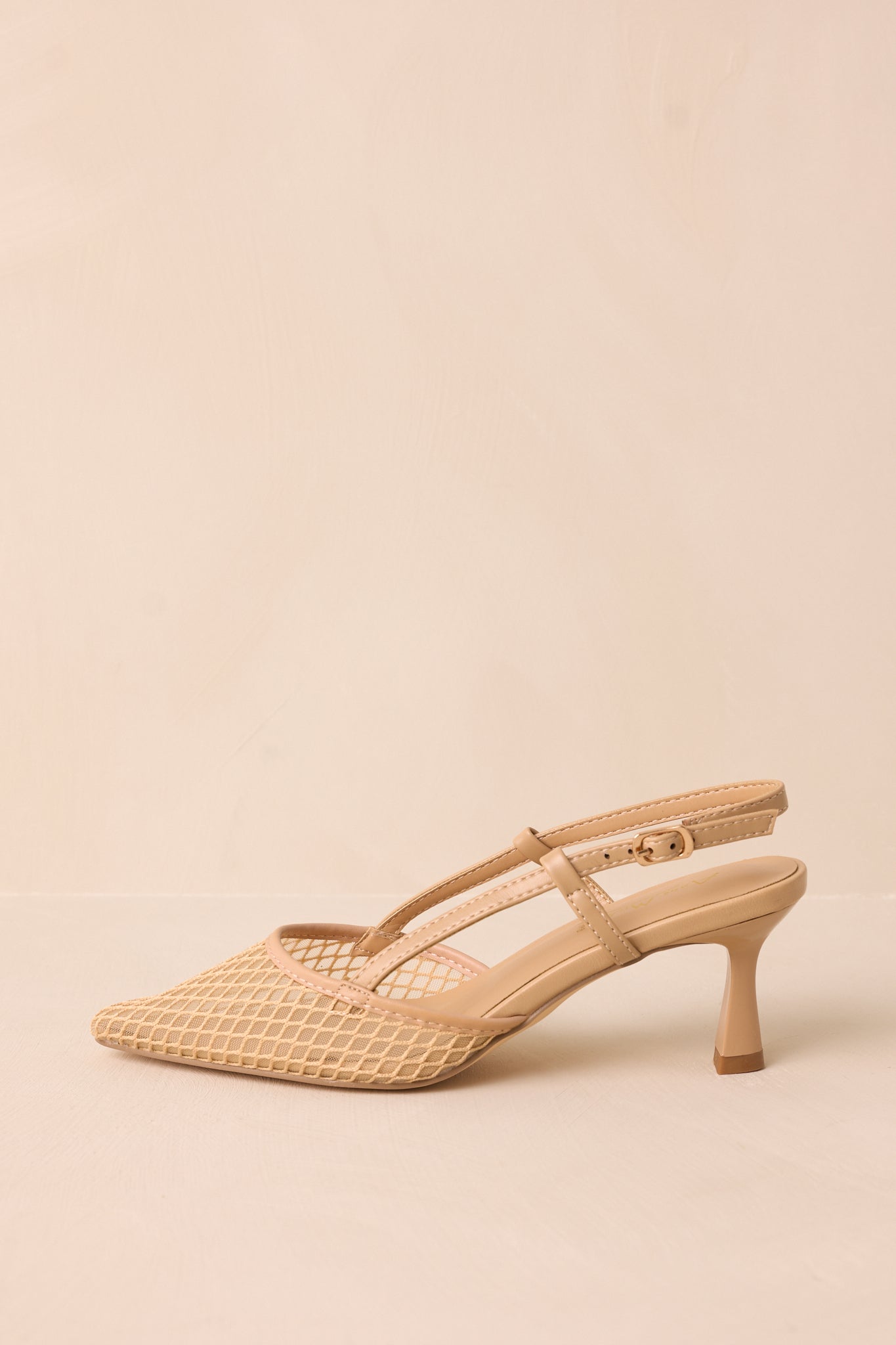 Side cropped view highlighting the adjustable beige slingback strap with gold buckle.