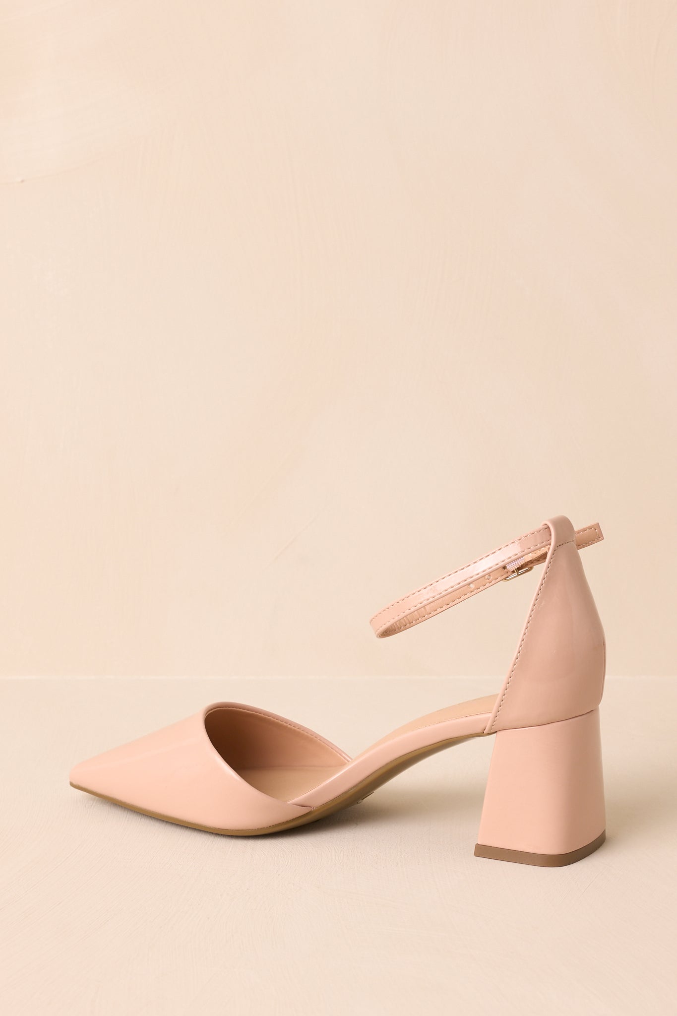 Dynamic angle showcasing both the heel height and reflective finish of the patent material.