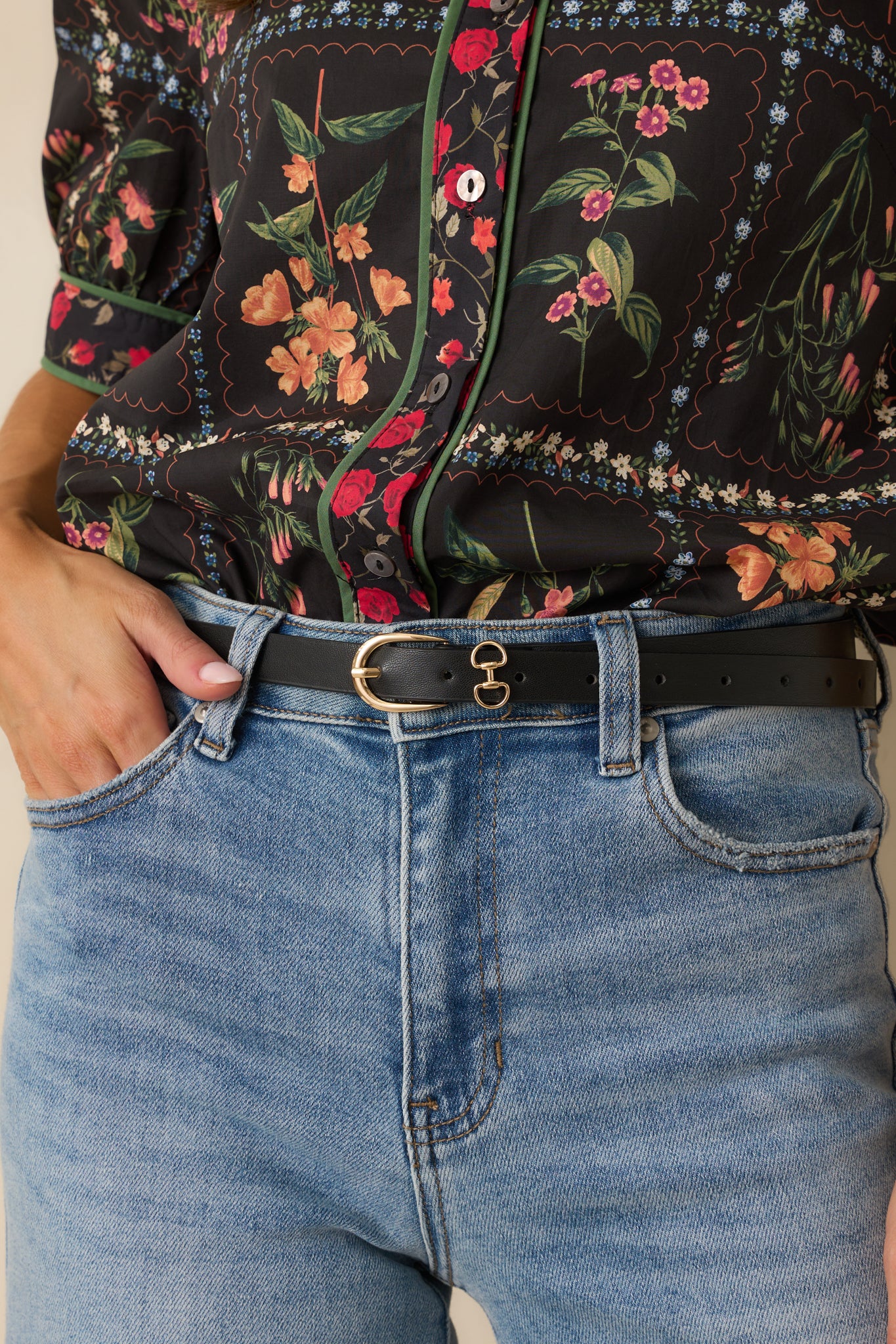 Zoomed-in image showing the texture of the faux leather, the gleaming gold-tone buckle, and the double ring accents.