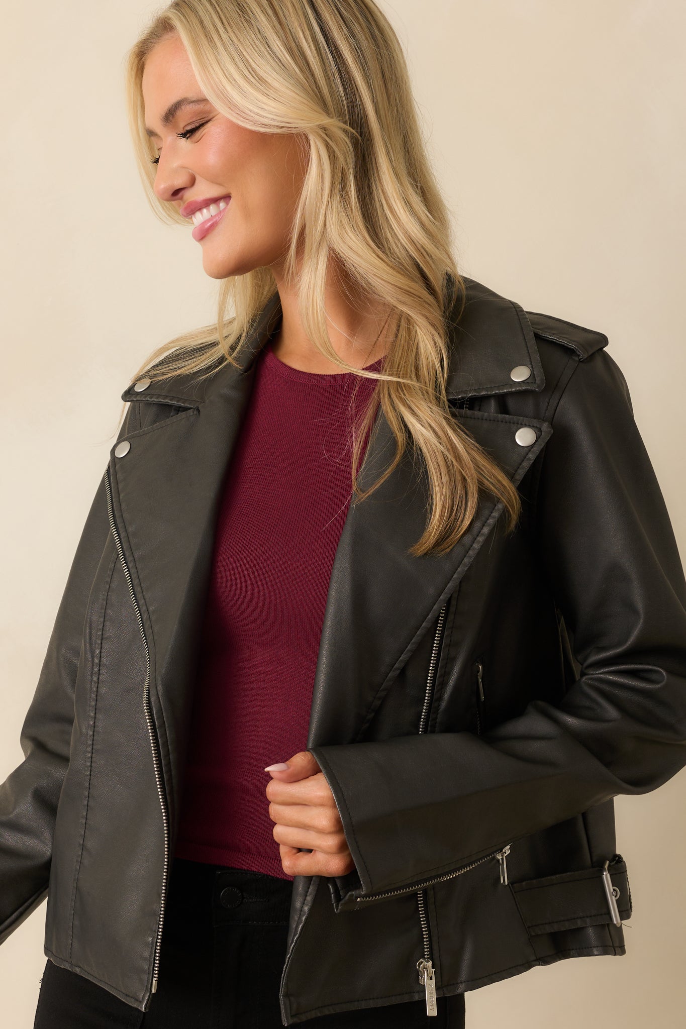 Close view of the zip front closure and collar detail on the black jacket.