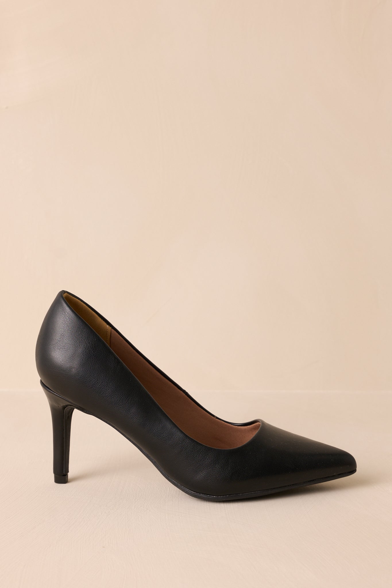 Shot showing the pointed toe and structured design of the pumps.