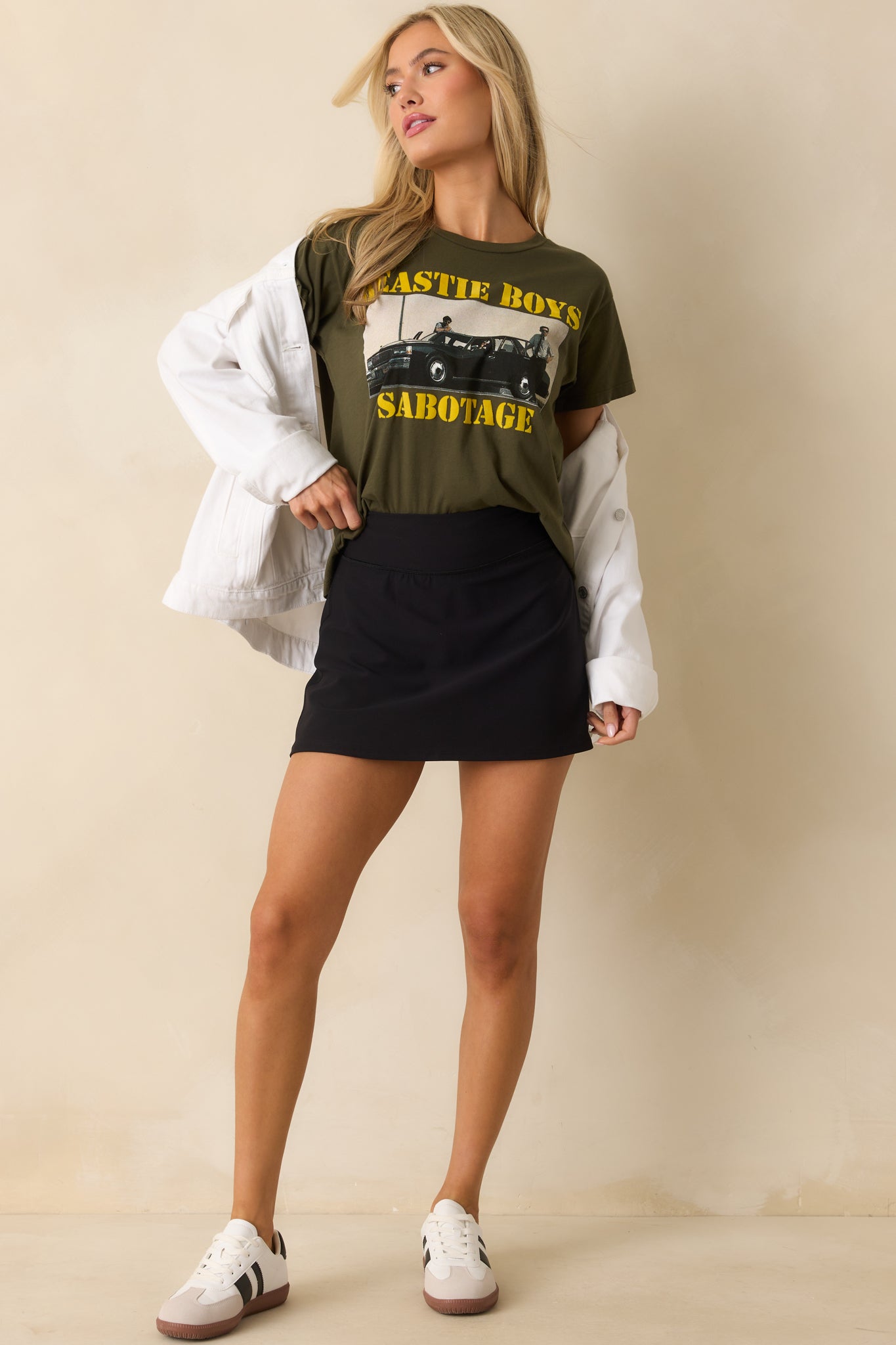 Sporty black skort featuring sweat-wicking 4-way stretch fabric for ease of movement.