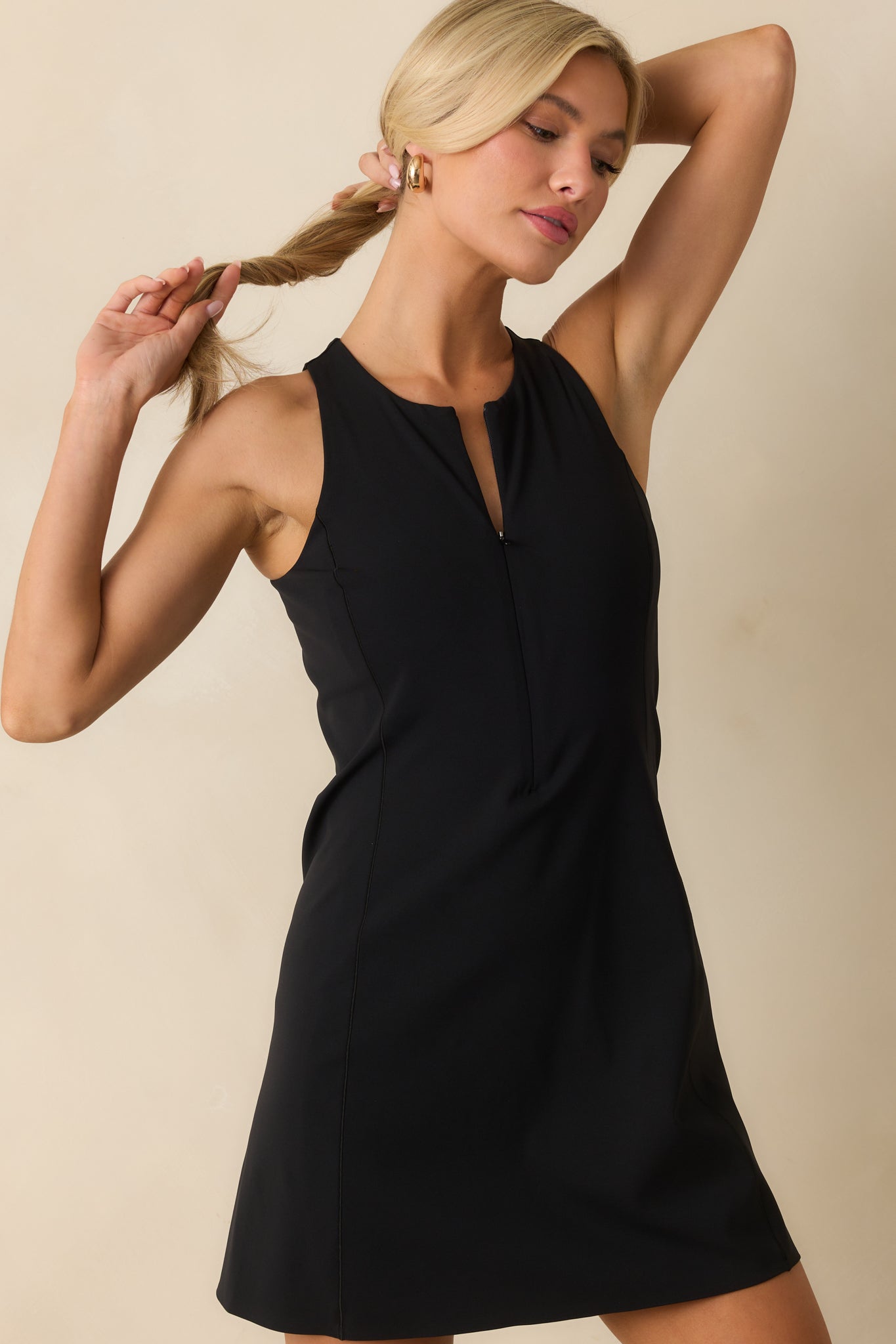 Cropped view highlighting the front zip and smooth texture of the black SPANXshape™ dress.