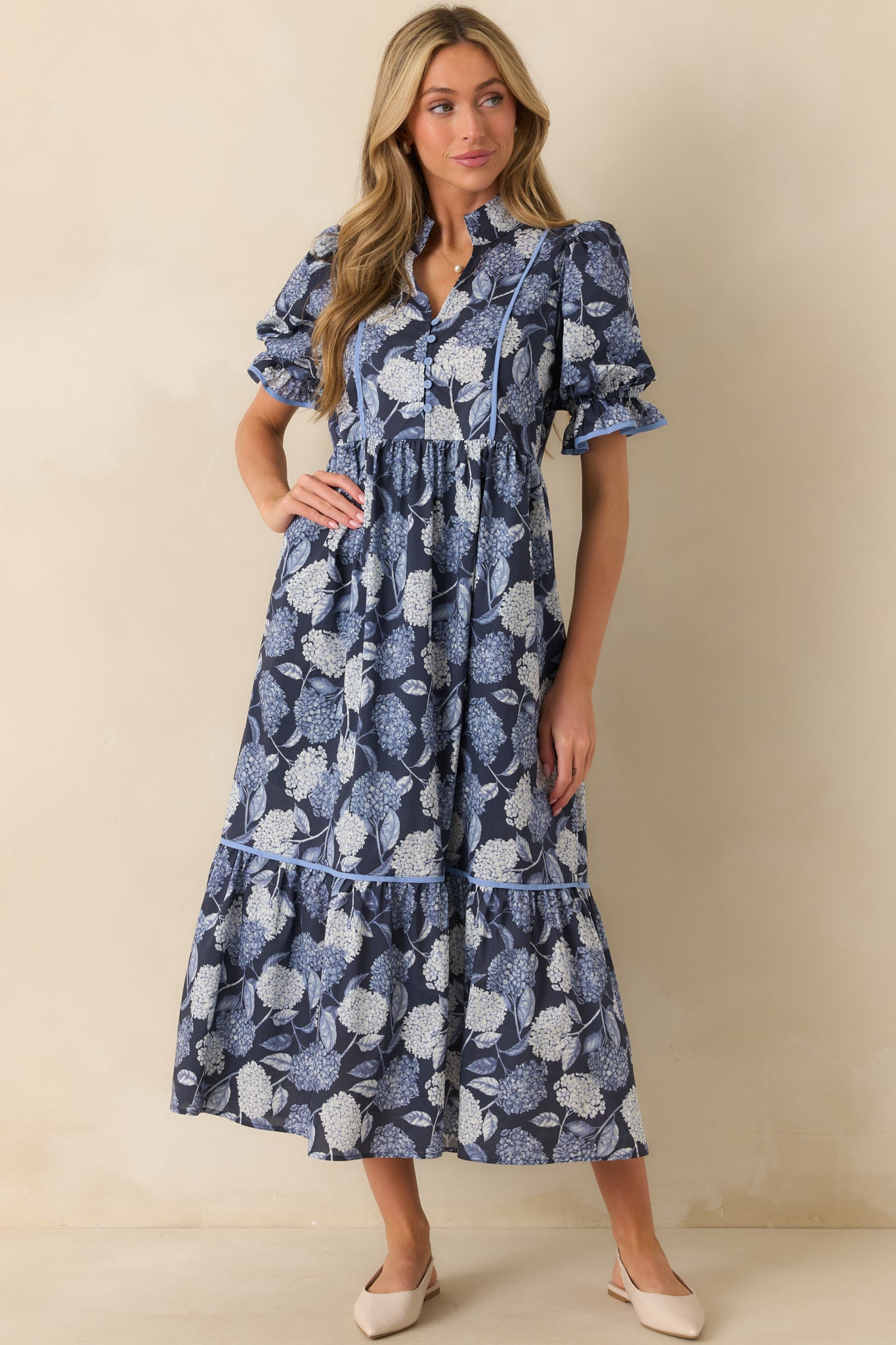A full length shot of the hydrangea print dress showing its flowing silhouette and maxi hemline.