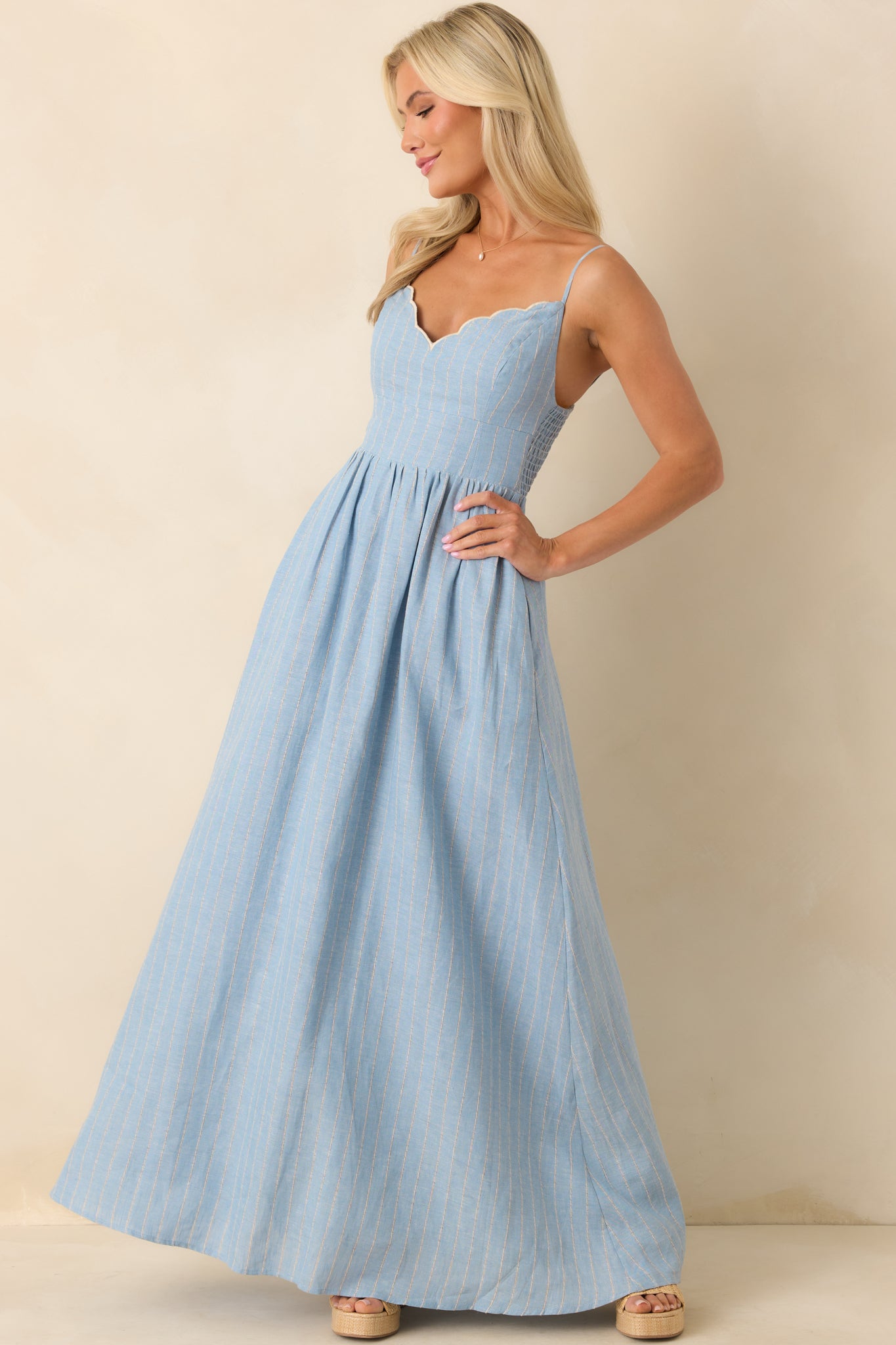 A full length side view focusing on the structured bodice and relaxed skirt with functional pockets.