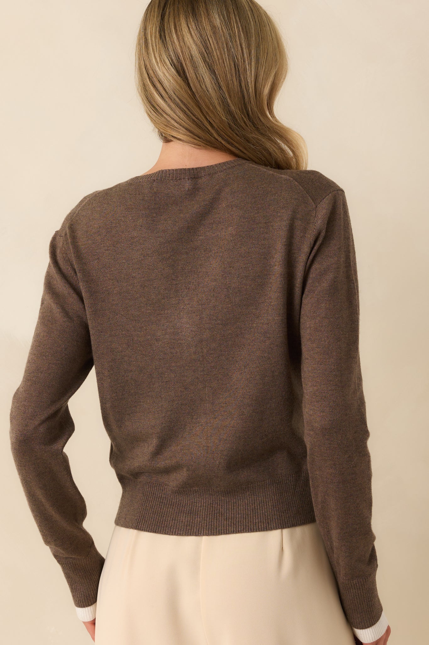 Back view of the cardigan showing the seamless knit construction and long sleeve coverage from behind.