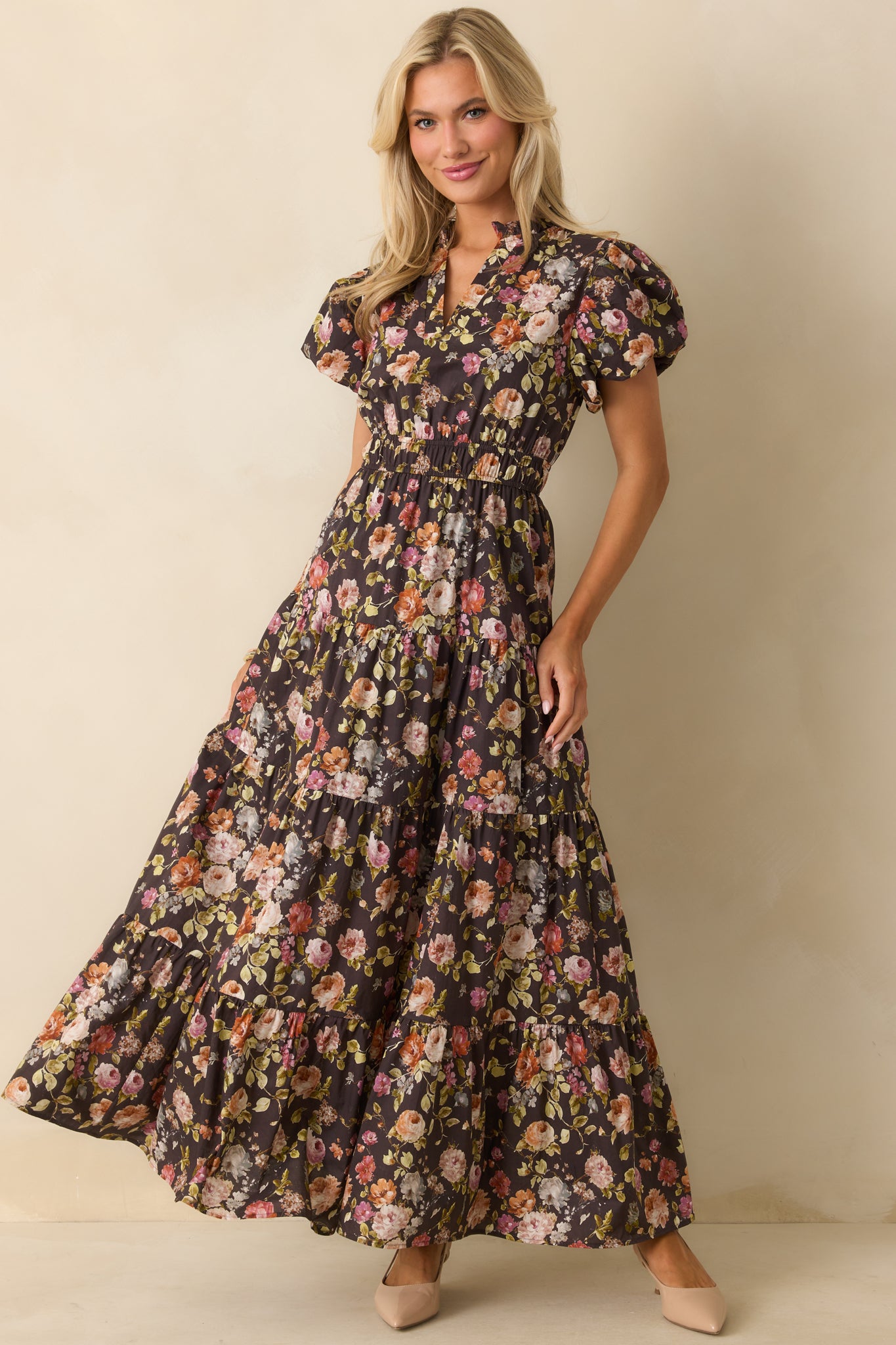 Tiered brown maxi dress with an elastic waistband and floral design.