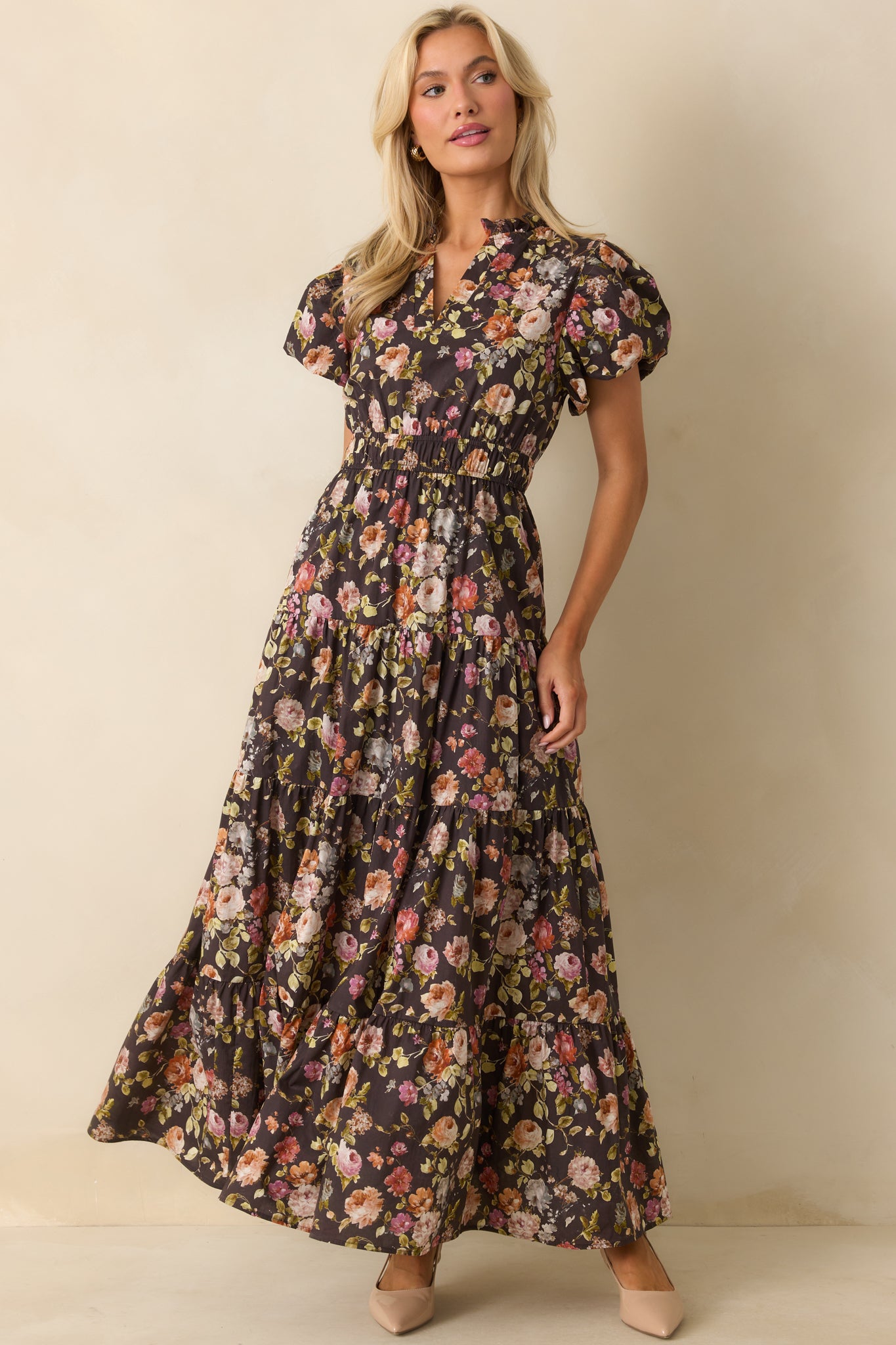 Flowing brown maxi dress blooming with multicolor florals and a tiered skirt.