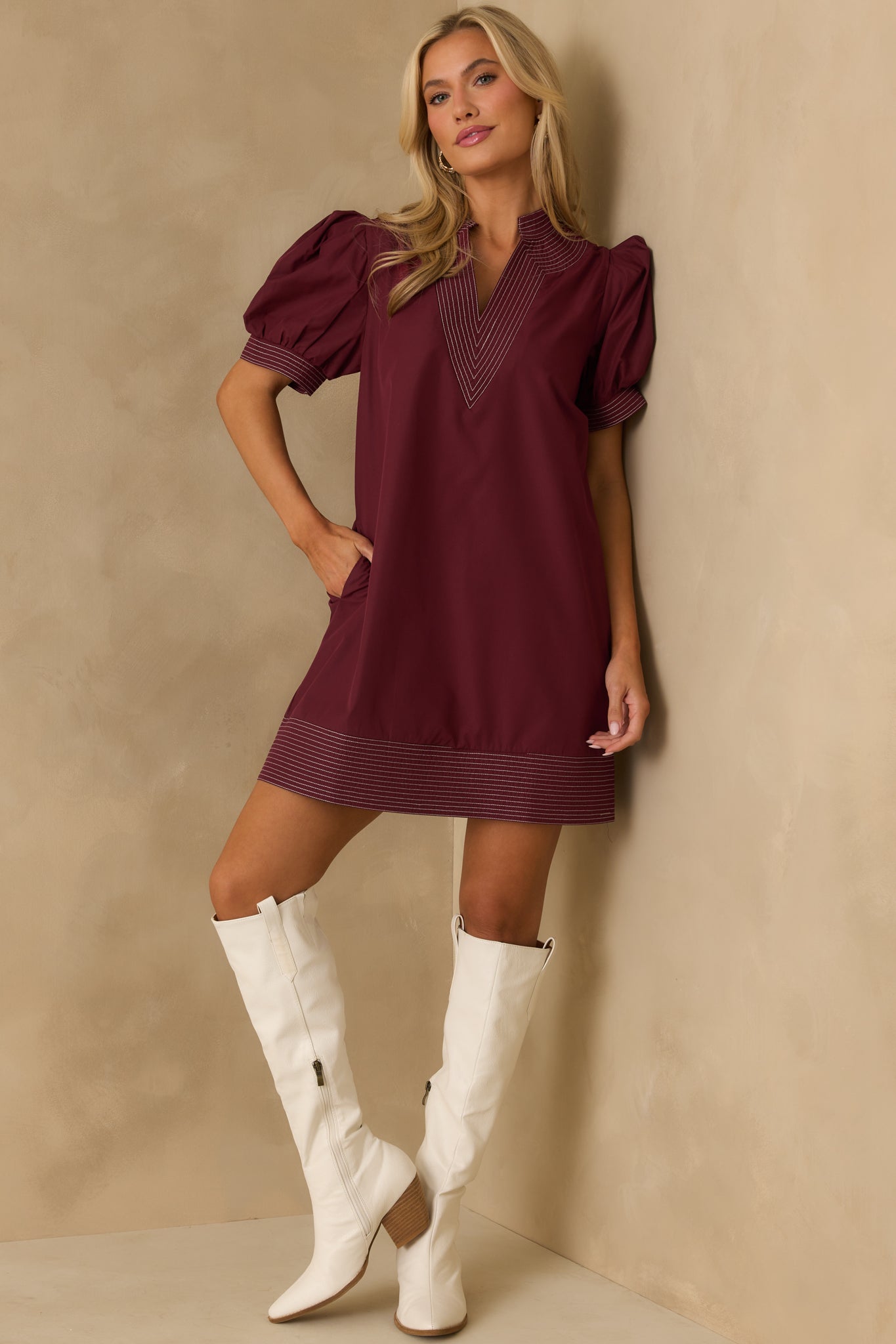 Playful puff sleeve burgundy mini dress featuring functional pockets.