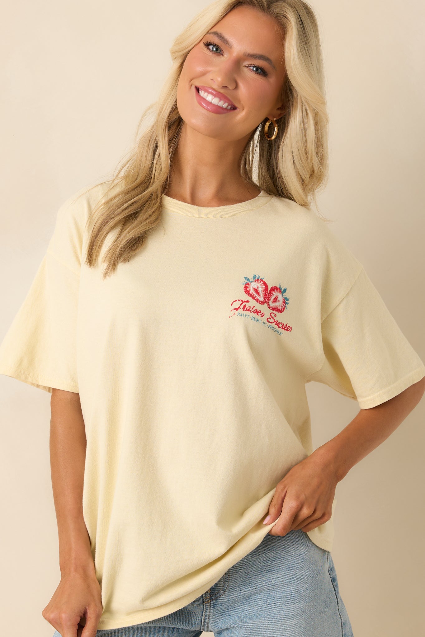 A close cropped shot featuring the short sleeves and minimal front design with subtle distressing on the chest graphic.