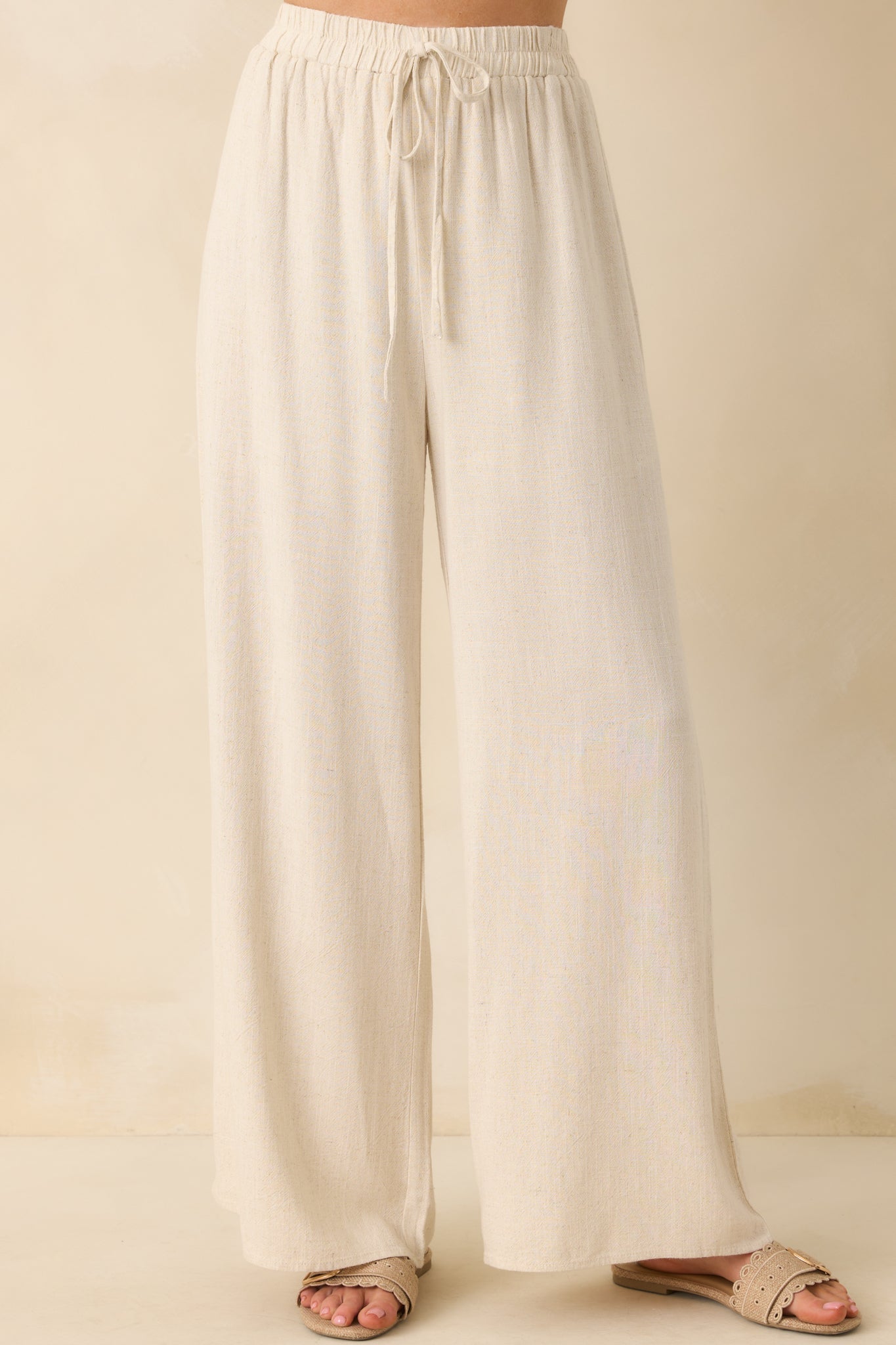 Close-up of the waistband area, showing the high rise, elastic band, and knotted self-tie feature.