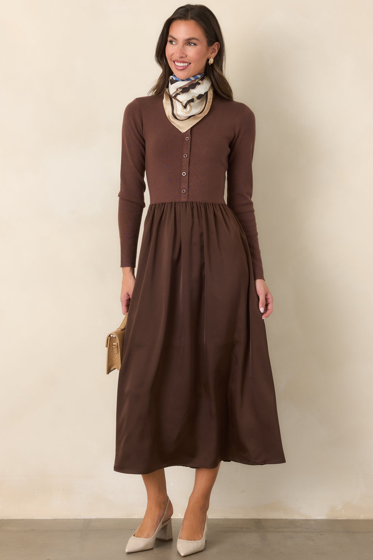 Cardigan-style burgundy dress combining a neat knit bodice with a lustrous satin midi skirt.