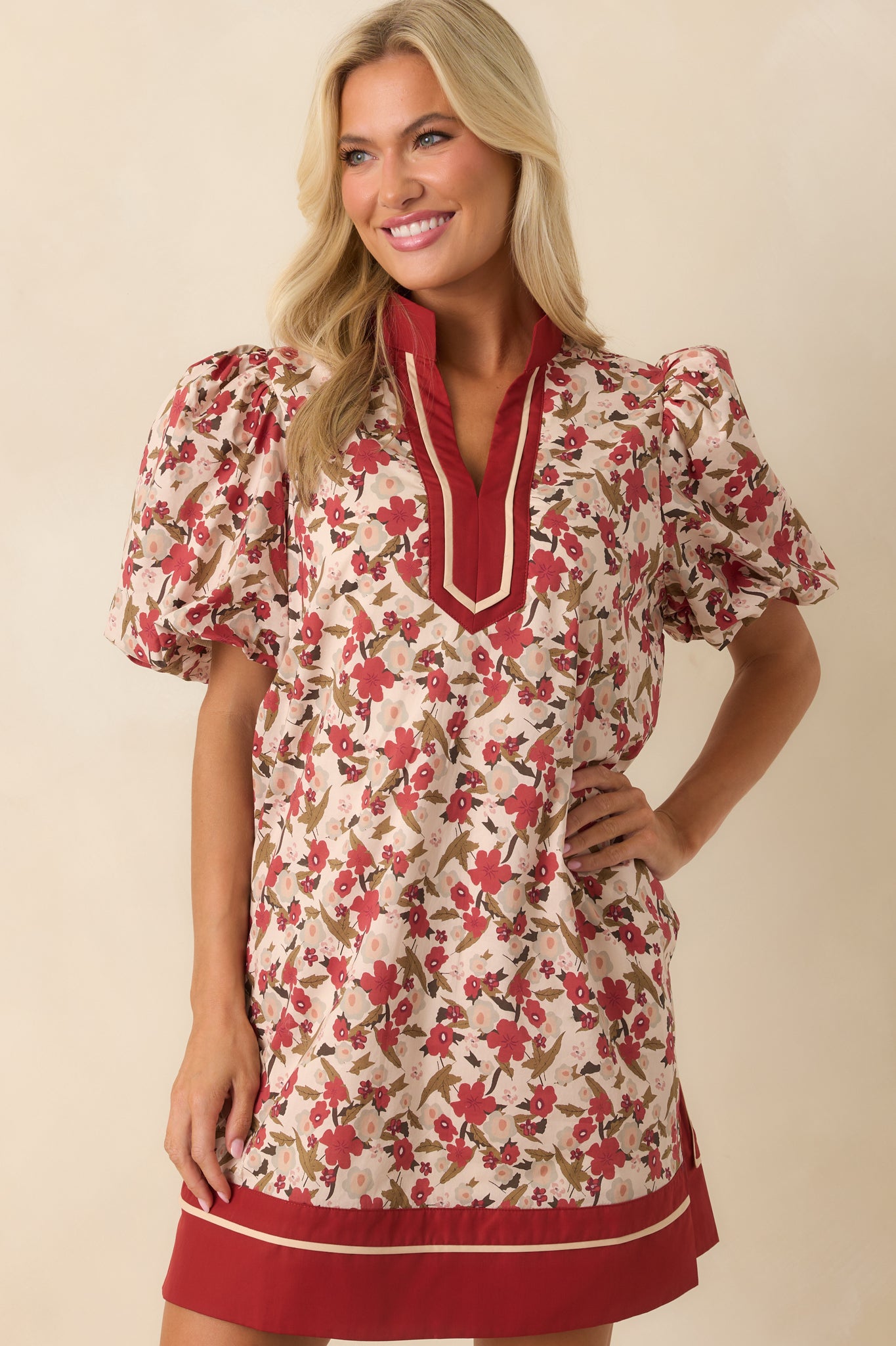 A cropped shot of the waist area displaying the floral print and the solid rust trim on the dress edges.