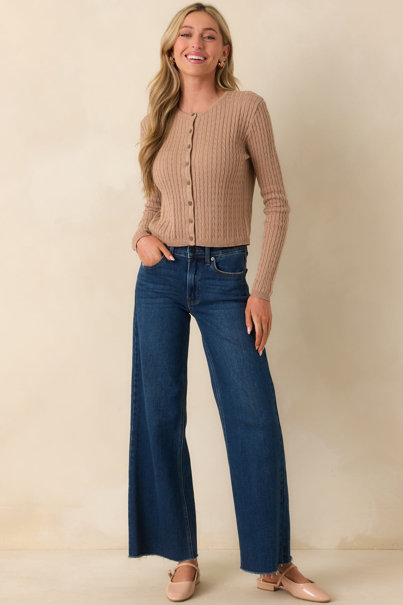 Full body photo of the cardigan, capturing the shape of the long sleeves and lightweight knit fabric.