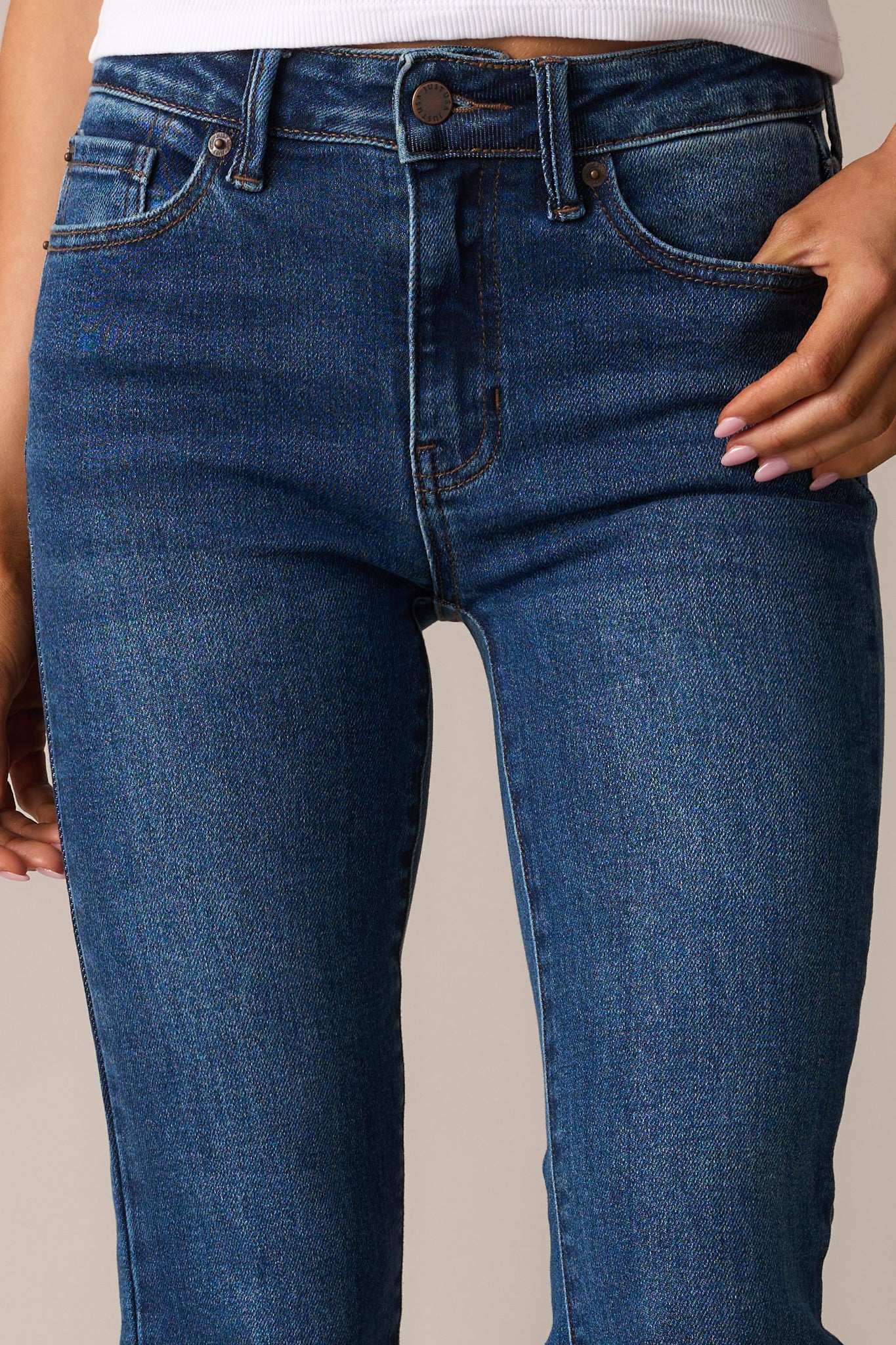 An extreme close-up of the denim texture, emphasizing the deep color and sturdy fabric construction.