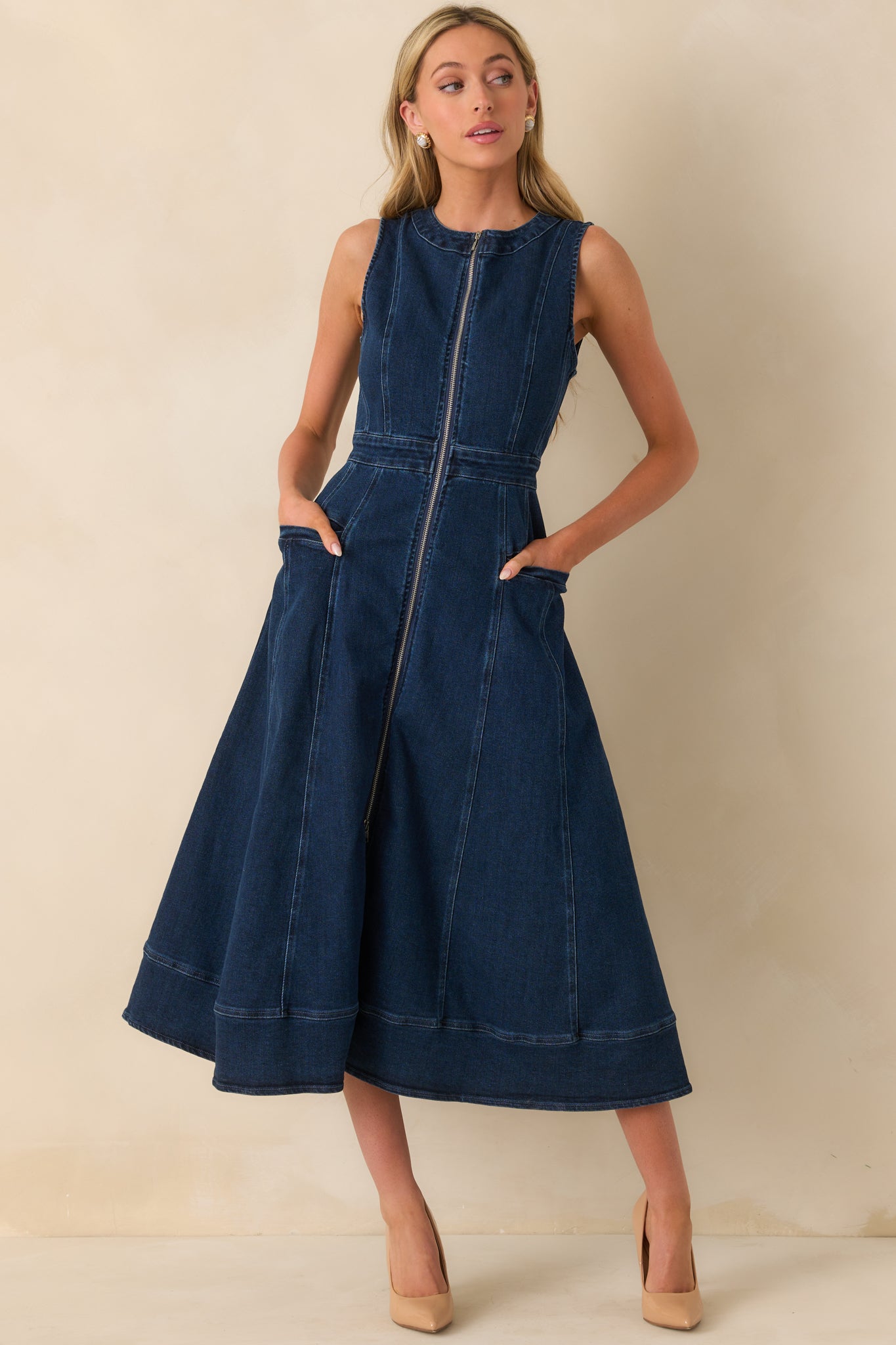 Front view of dark wash midi dress with visible full-length zipper and structured fitted waist.