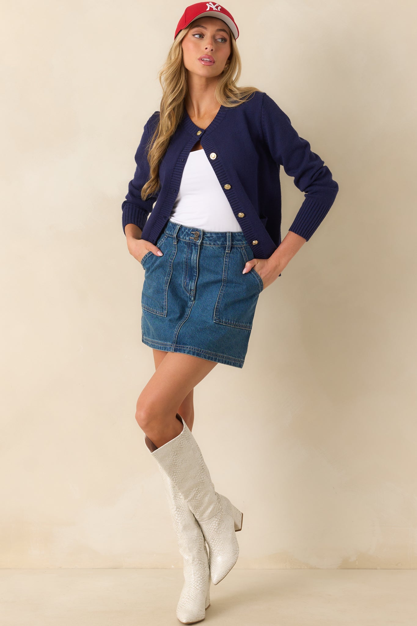 Mini skirt in medium wash denim with a casual above-the-knee cut and functional patch pockets.