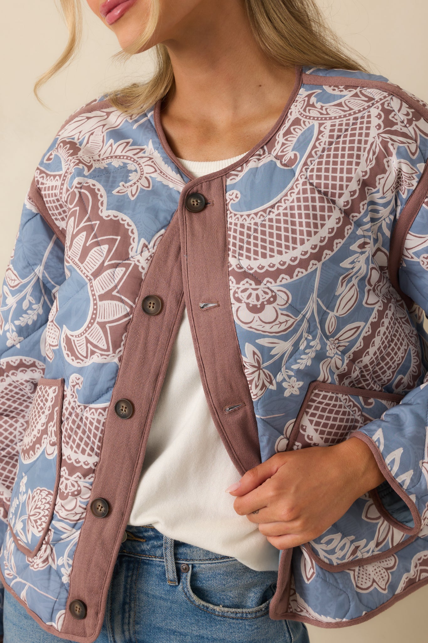 Detailed shot of the paisley floral quilting, capturing the texture and color contrast in the design.