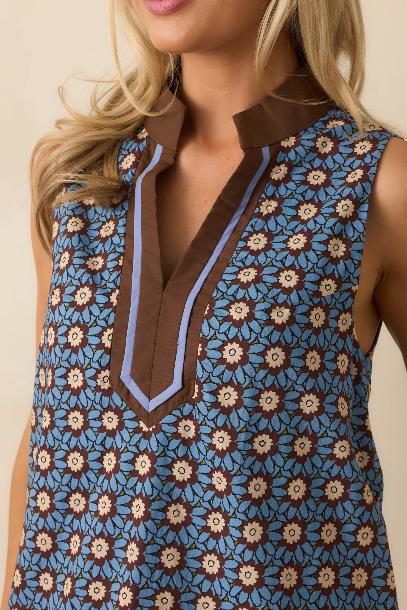 Close detail of dusty blue floral print and textured brown contrast trim.