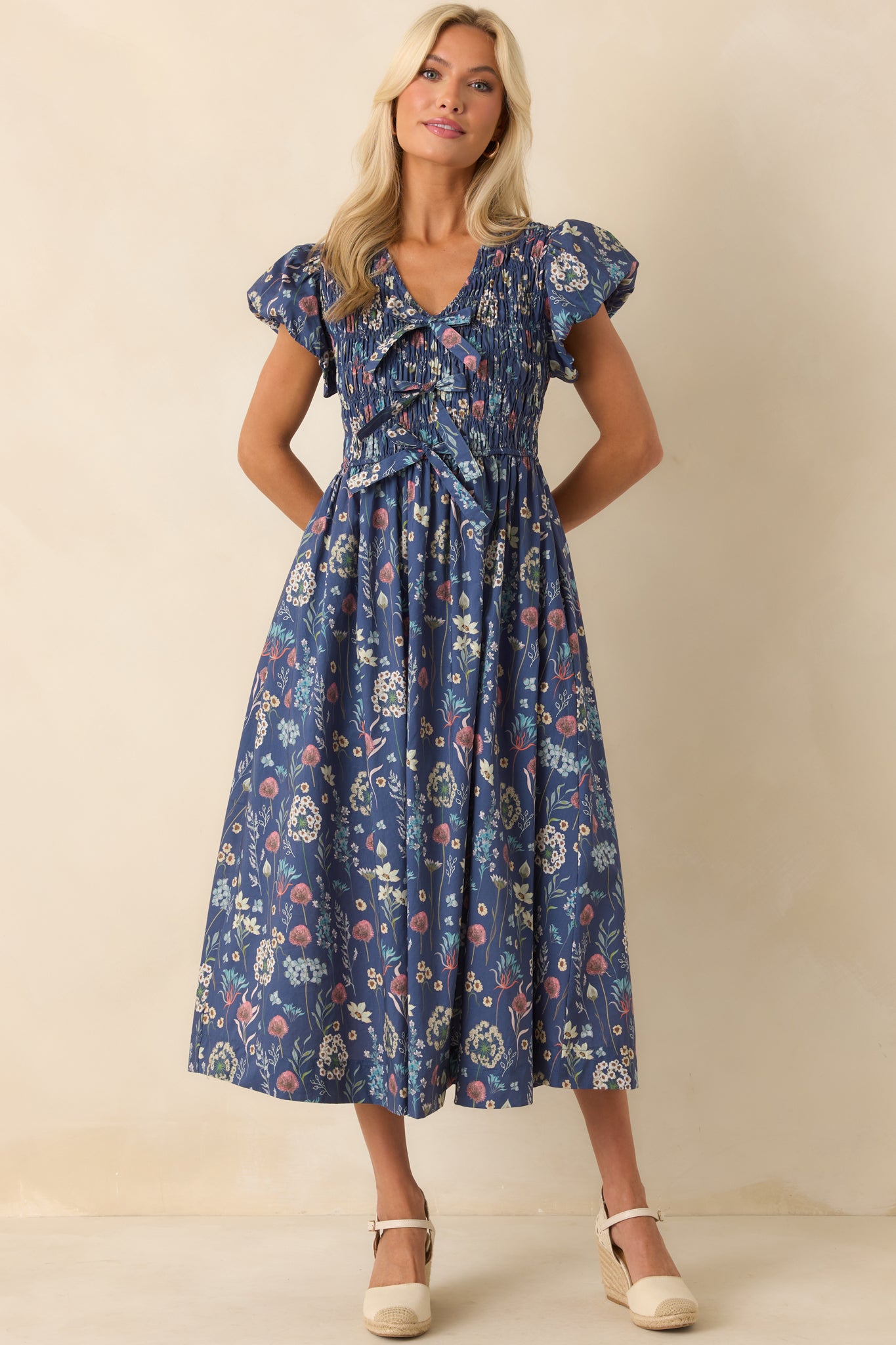 Front-facing full body view capturing the full silhouette of the dress, including the functional pockets and puff sleeve shape.