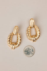 Size comparison of these gold earrings with rectangular-shaped studs, textured dangles, secure post backings.