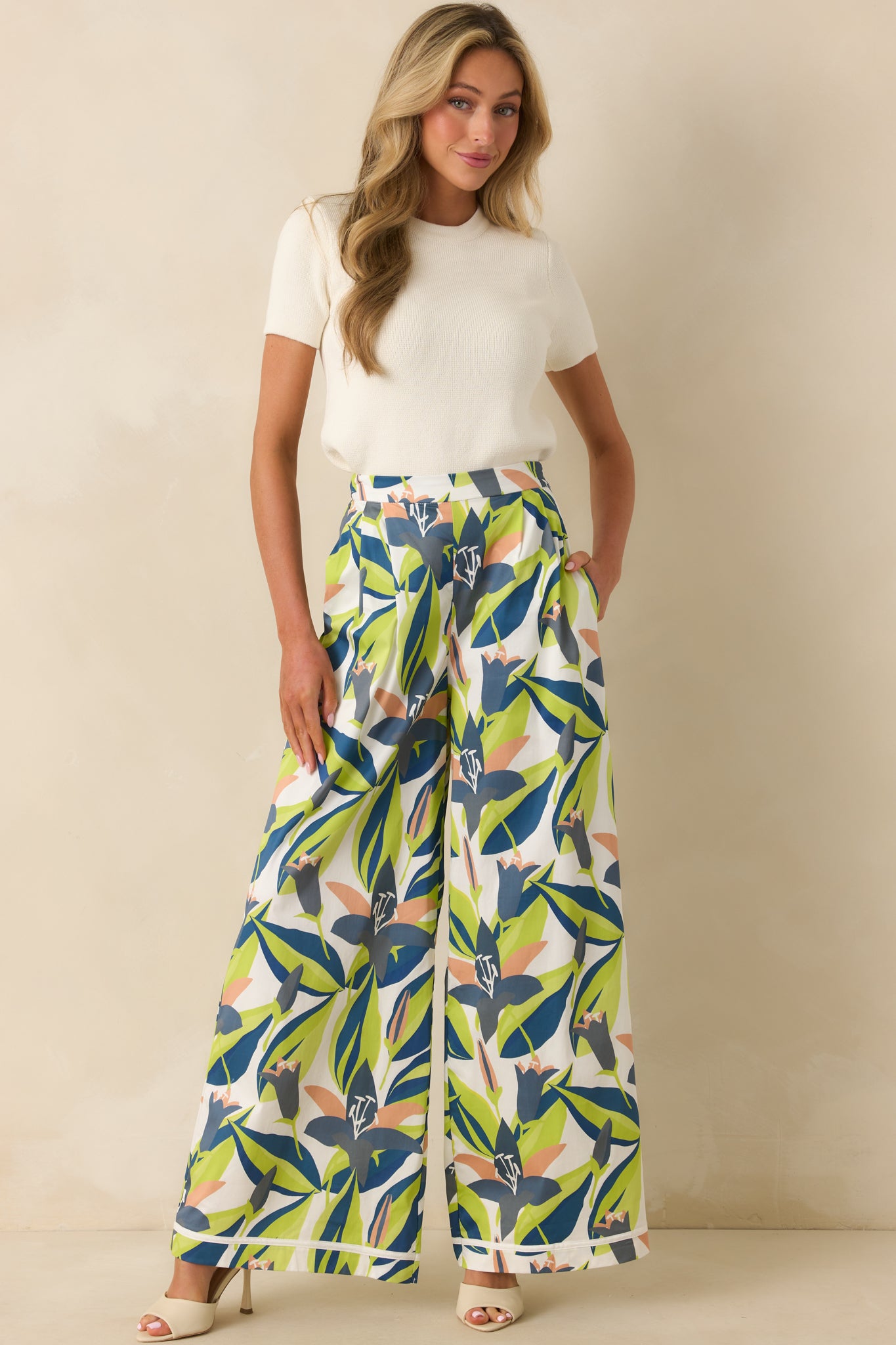Full front-facing view of floral print pants highlighting high-rise waist and relaxed wide-leg silhouette.