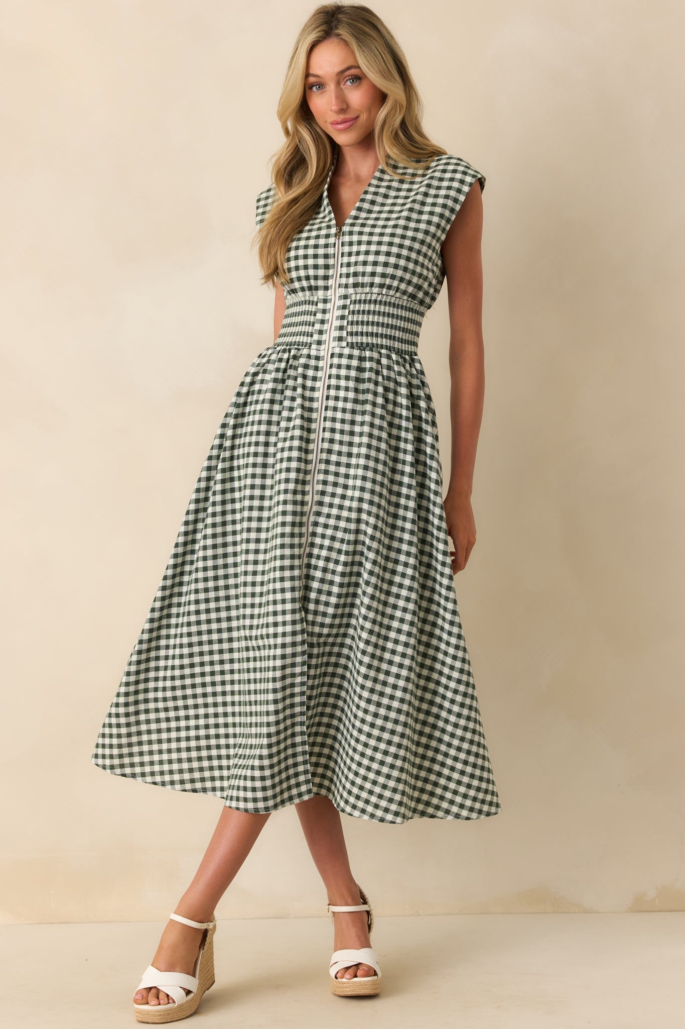 Green gingham midi dress displayed from the front, emphasizing the structured shoulders and fitted waist.