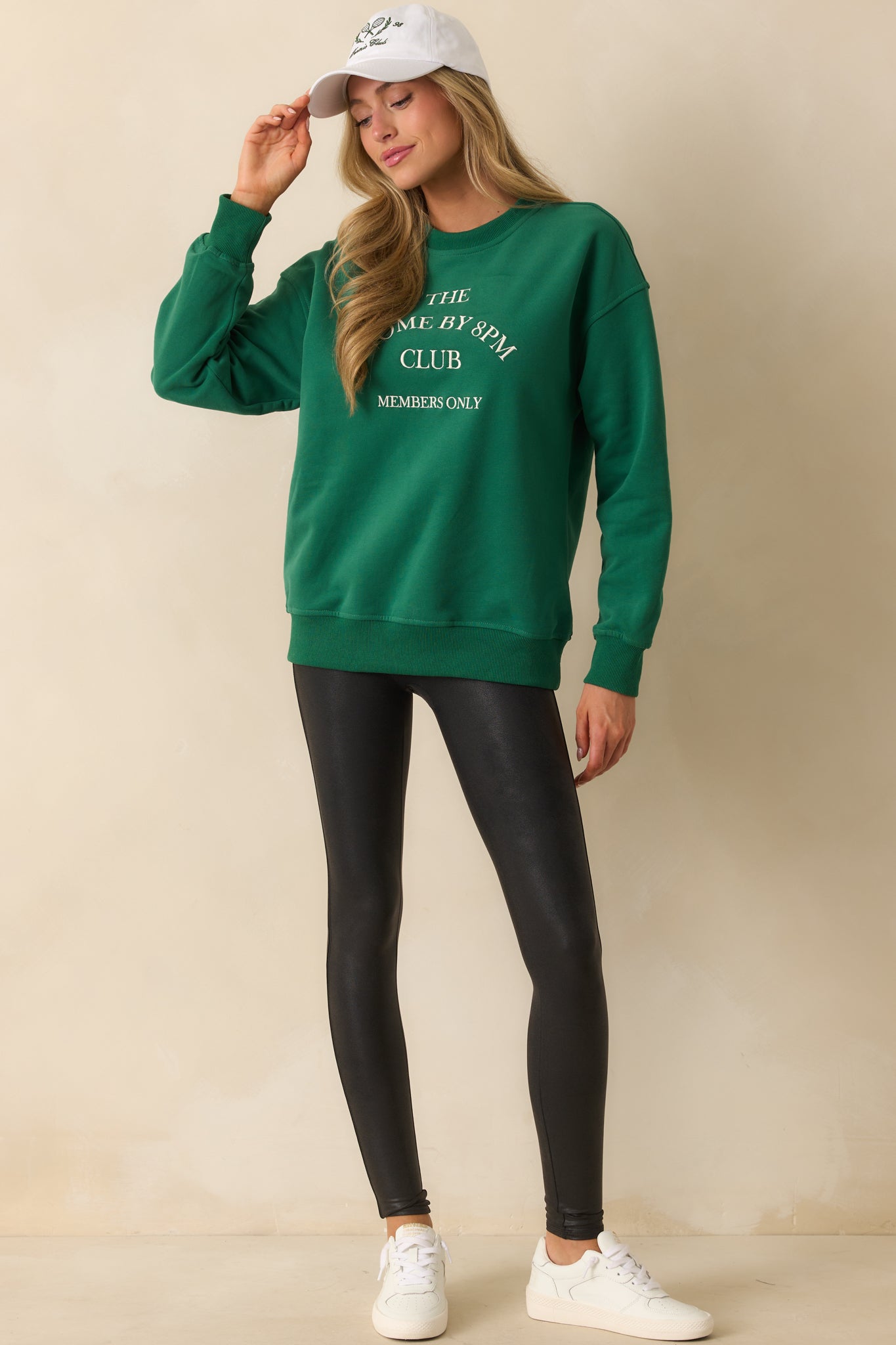 Forest green sweatshirt with bold white embroidered slogan across the chest, finished with ribbed trim.