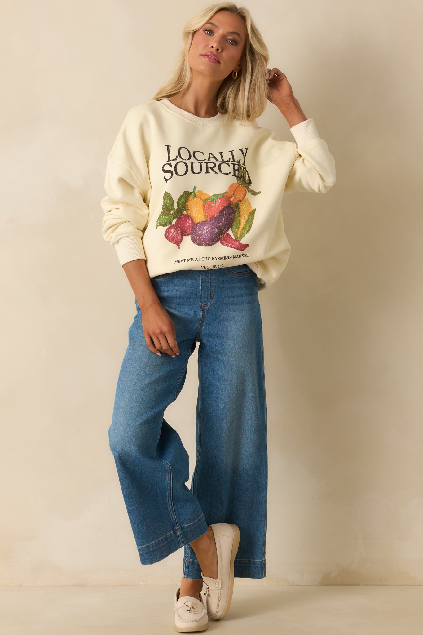 Full front look at ivory sweatshirt featuring vintage-style 'Locally Sourced' market motif.
