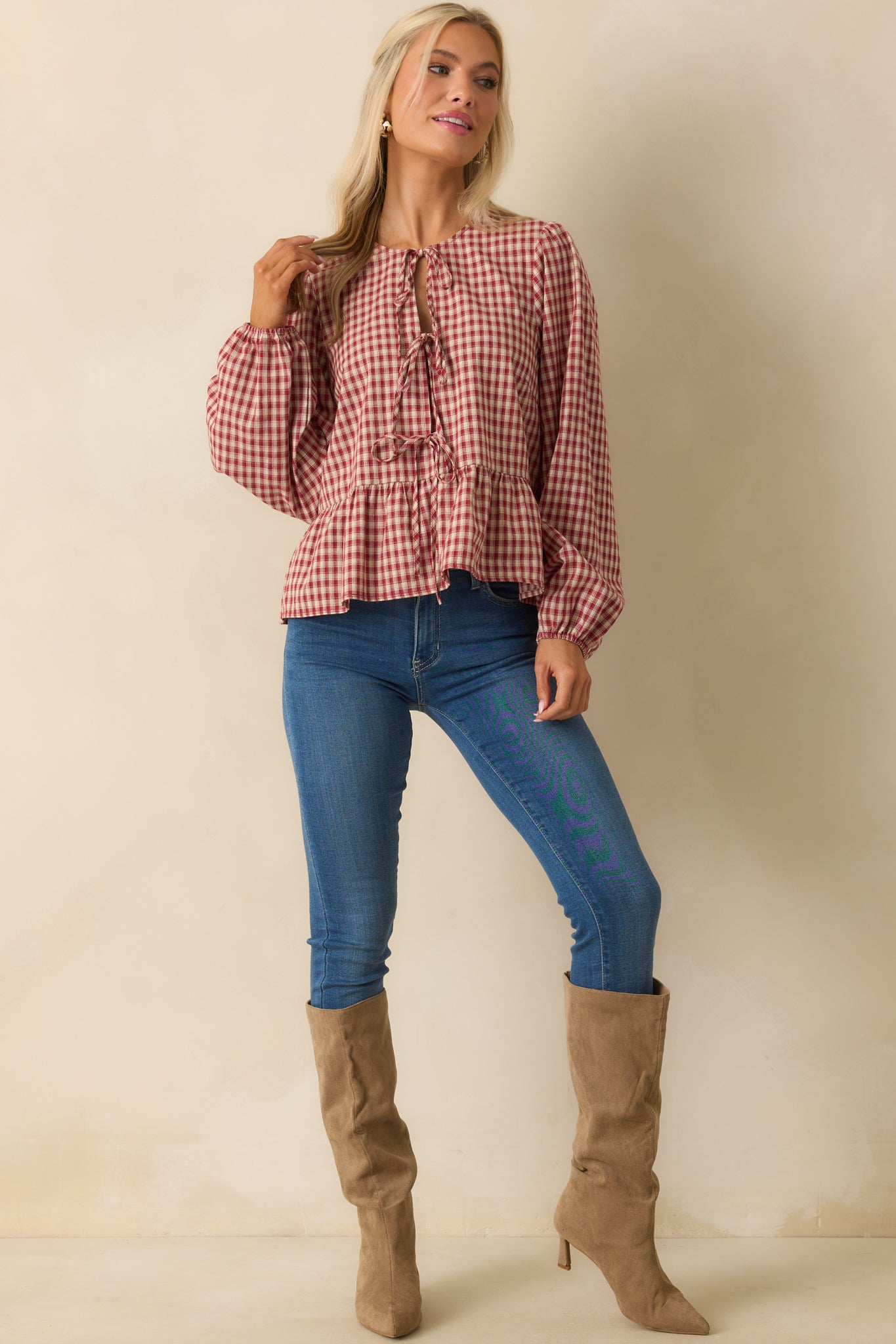 Front-facing image of gingham blouse featuring round neckline, long balloon sleeves, and elastic cuffs.