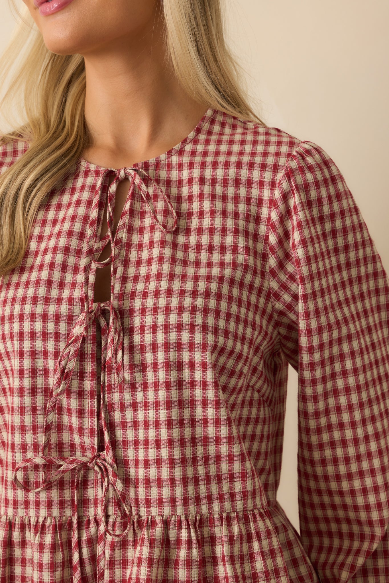 Close-up detail of gingham fabric with self-tie bow and panel construction.