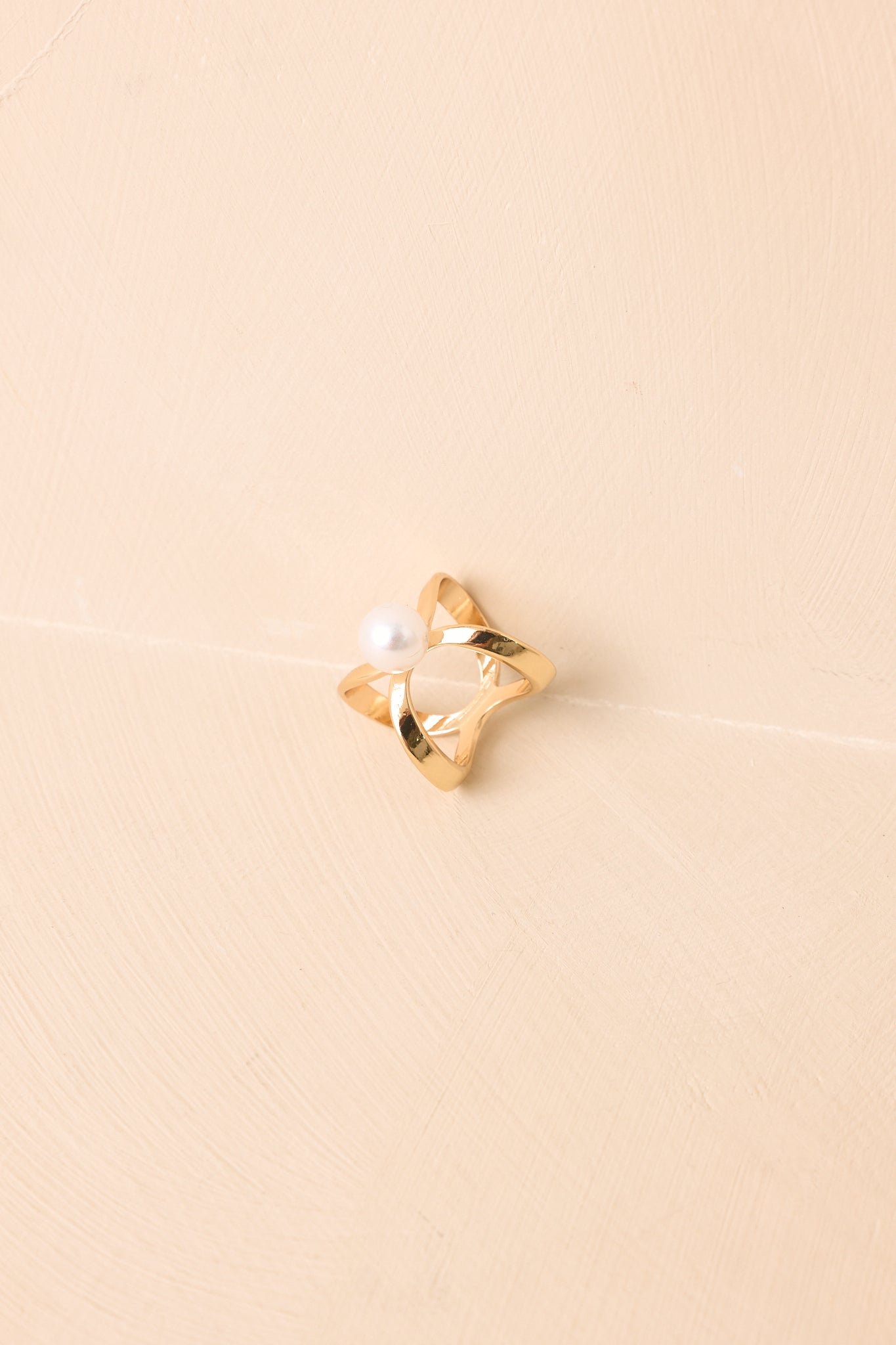Gold scarf ring featuring a modern open design with a faux pearl accent.