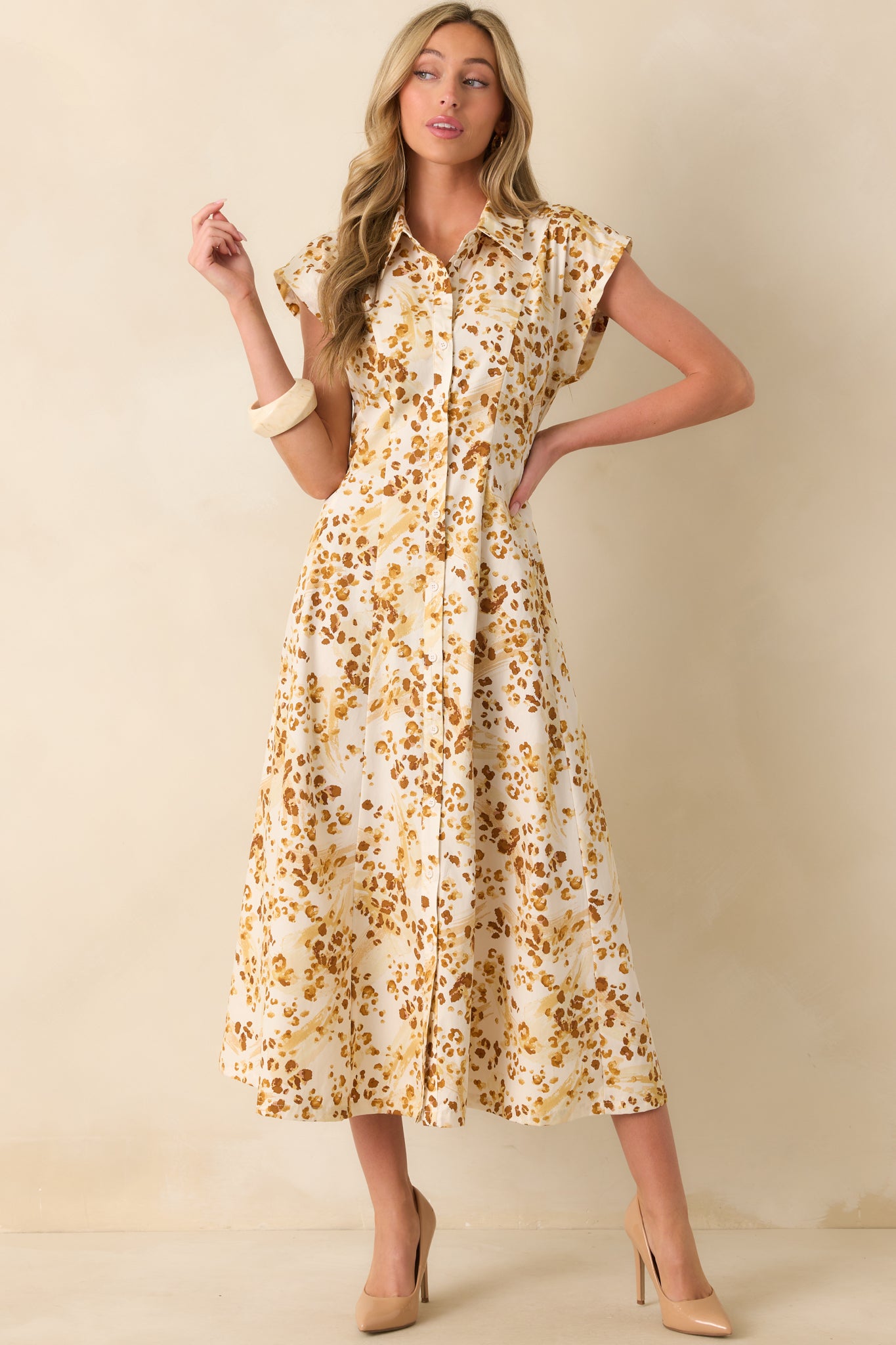 Golden yellow maxi dress with abstract animal print, collared neckline, and short cap sleeves.