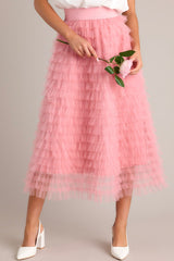 Front view of this pink skirt that features a high-waist design with an elastic waistband for a comfortable fit, adorned with charming ruffle tulle detailing throughout.