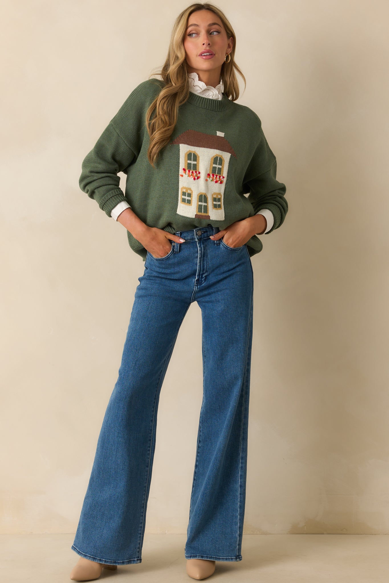 Green cotton-blend sweater with house motif, crew neckline, and relaxed fit shown in a full front view.