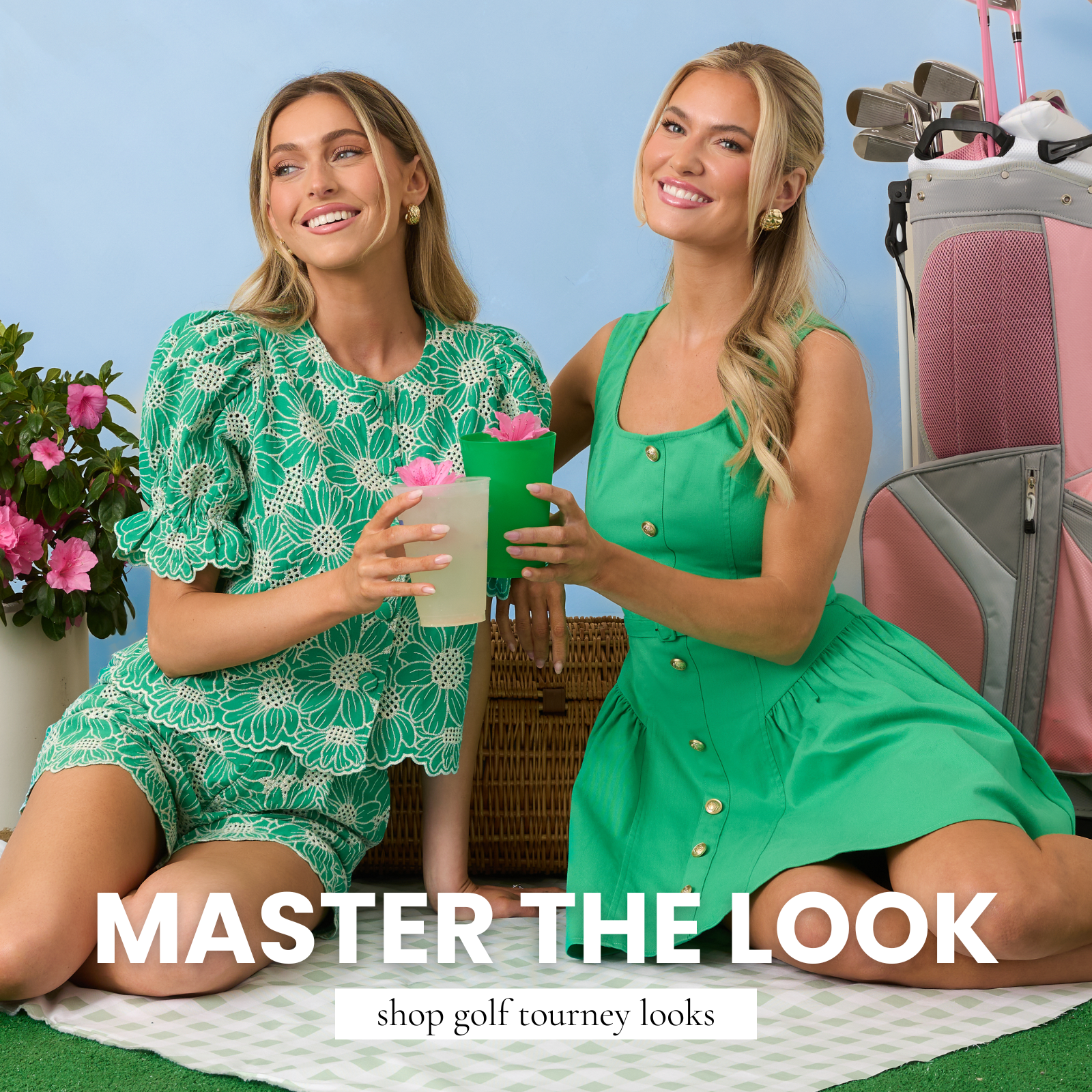 Two women wearing green dresses and sets styled for a golf-inspired event, sitting with drinks beside a golf bag. This image leads to shop golf tourney looks and highlights polished, sporty-chic outfits perfect for spring events.