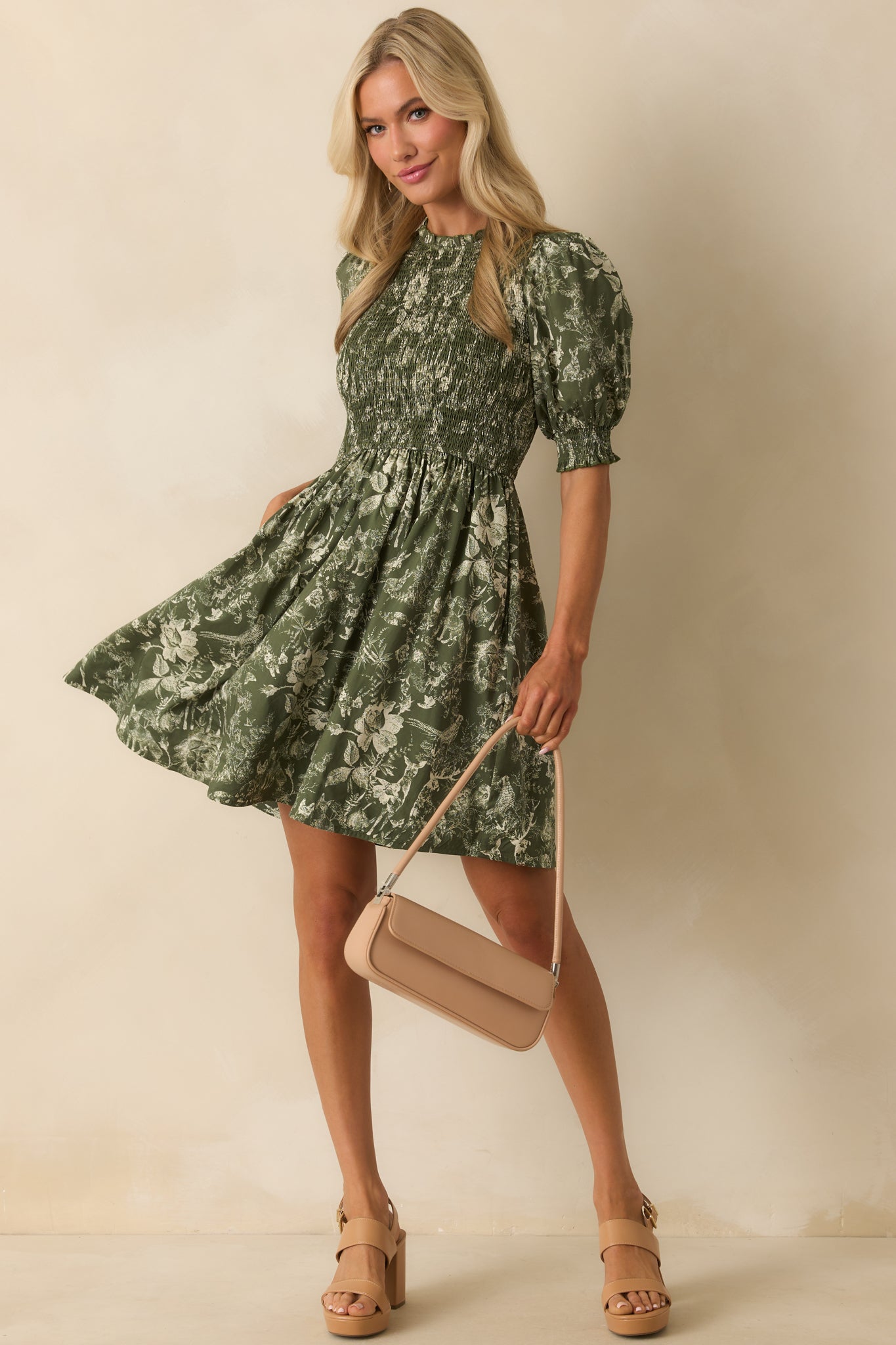 Green mini dress with ivory nature-inspired toile print, fully smocked bodice, and short puff sleeves.