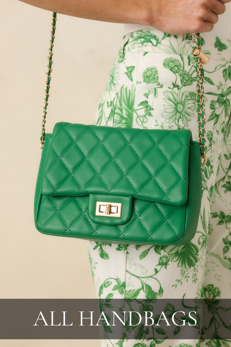 Green quilted crossbody handbag with gold chain strap styled with a green floral skirt representing the handbags collection.