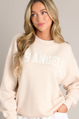 Close up front view of this natural embroidered sweatshirt that features 