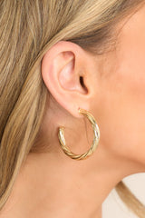 These earrings feature gold hardware, a twist like design, and a secure post backing.
