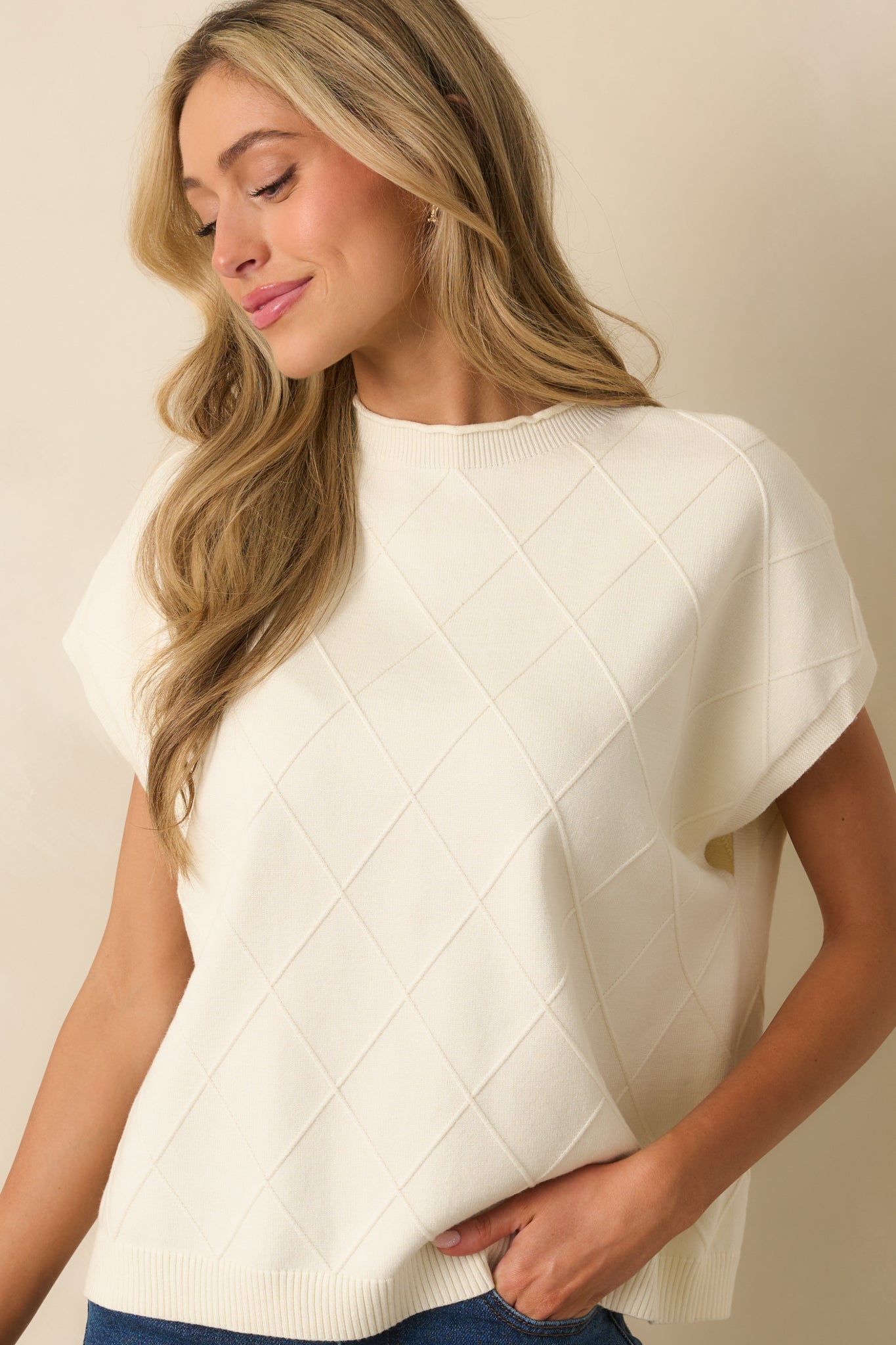 Ivory sweater highlighting rolled hem neckline and folded dolman sleeves