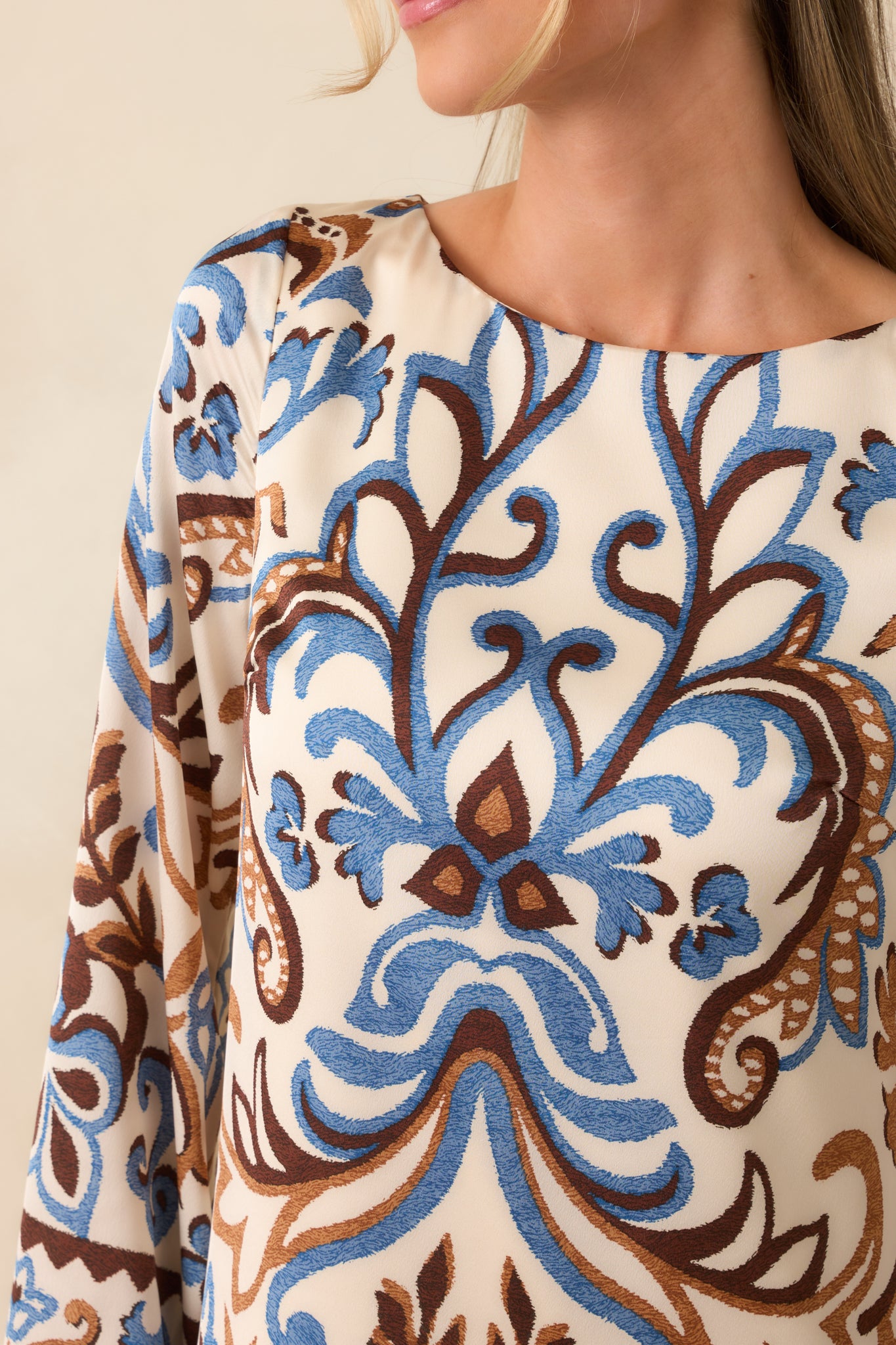 Close-up of the fabric texture and floral paisley print details.