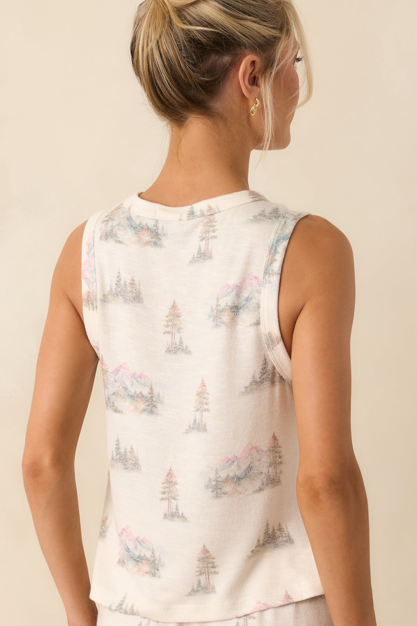 Back view of the tank top highlighting the sleeveless design, relaxed fit, and clean ivory back panel.