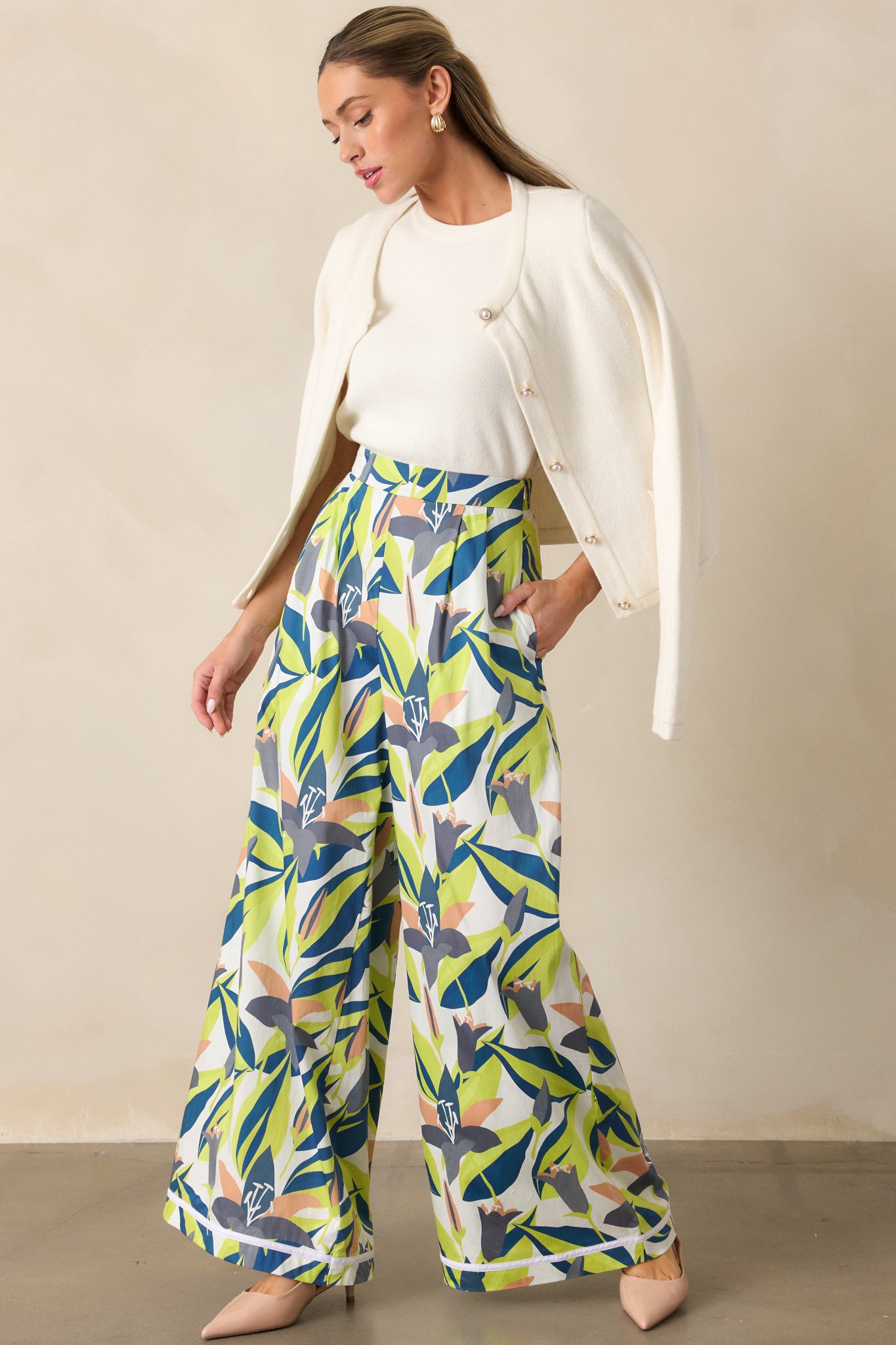 Ivory cardigan with crew neckline, long sleeves, and functional faux pearl button front, shown front facing.