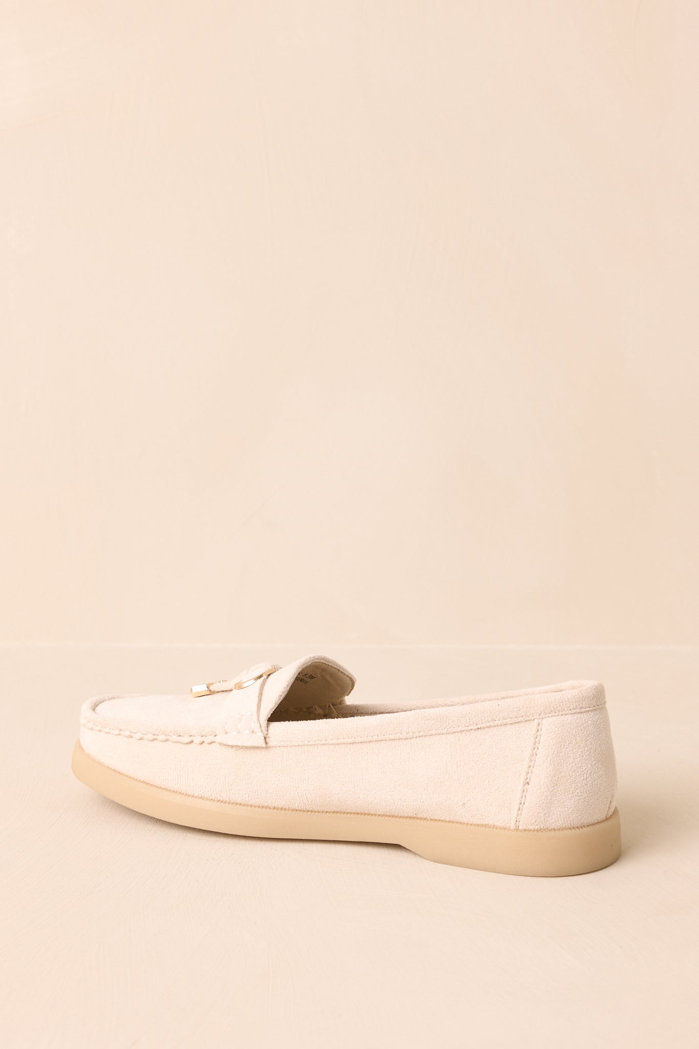 A back view of the ivory faux suede loafers with a beige platform sole.