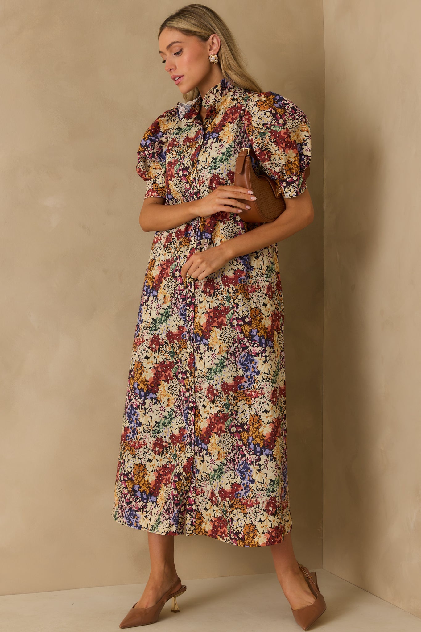 Romantic ivory floral dress with functional pockets and puff sleeves adding volume at the shoulders.